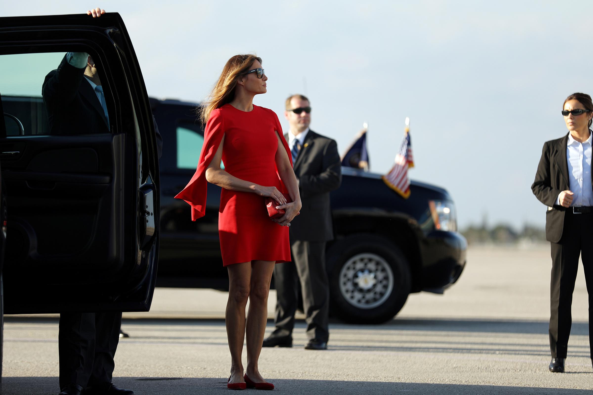 First Lady Melania Trump wearing red split-sleeve dress and red flats arrives to welcome U.S. President Donald Trump (not pictured) at West Palm Beach International airport in West Palm Beach, Florida, U.S., Feb. 3, 2017.