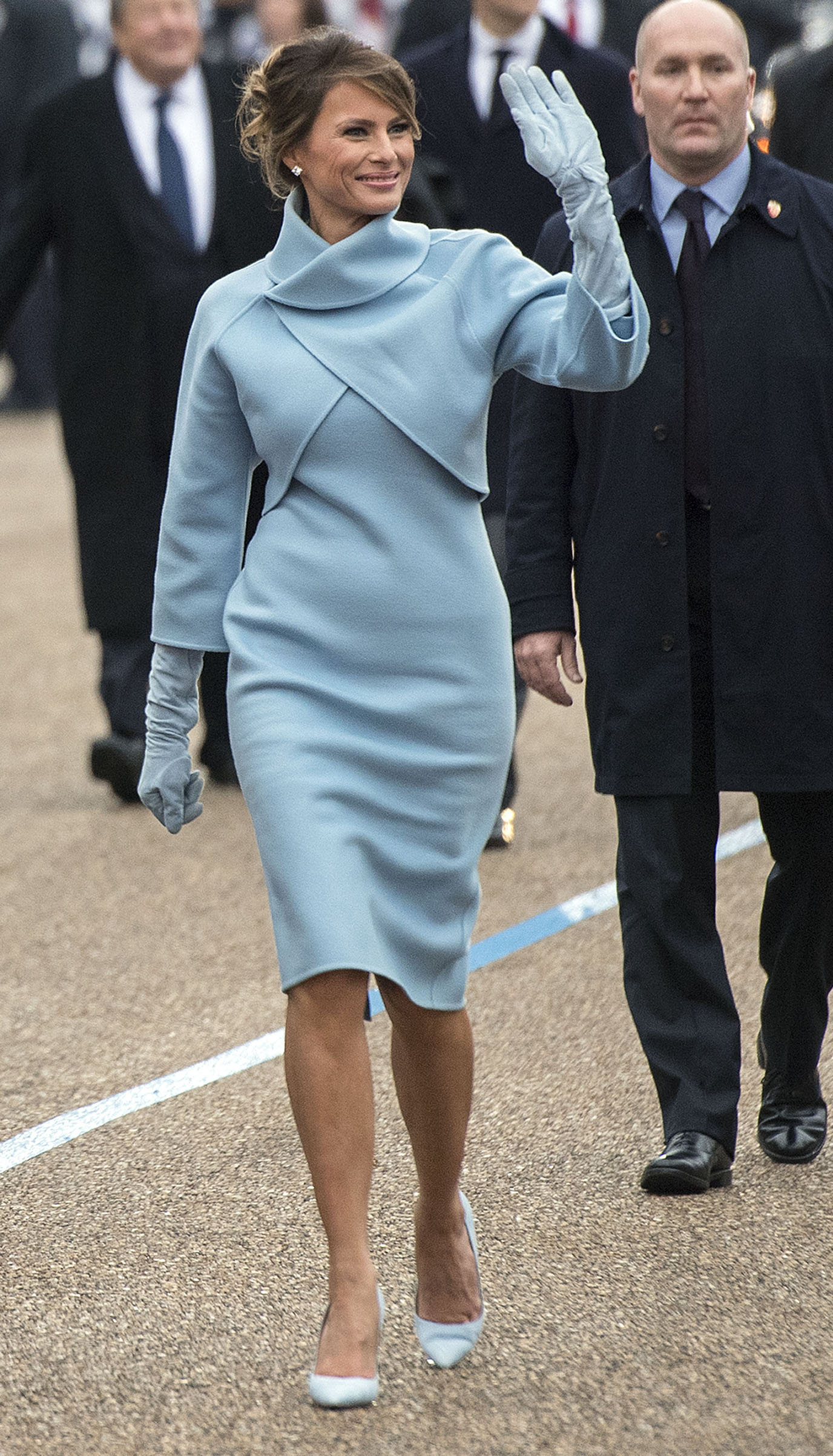 First lady Melania Trump wearing a powder blue cashmere skirt suit by the Ralph Lauren Collection, waves to supporters in the inaugural parade on January 20, 2017 in Washington, DC.