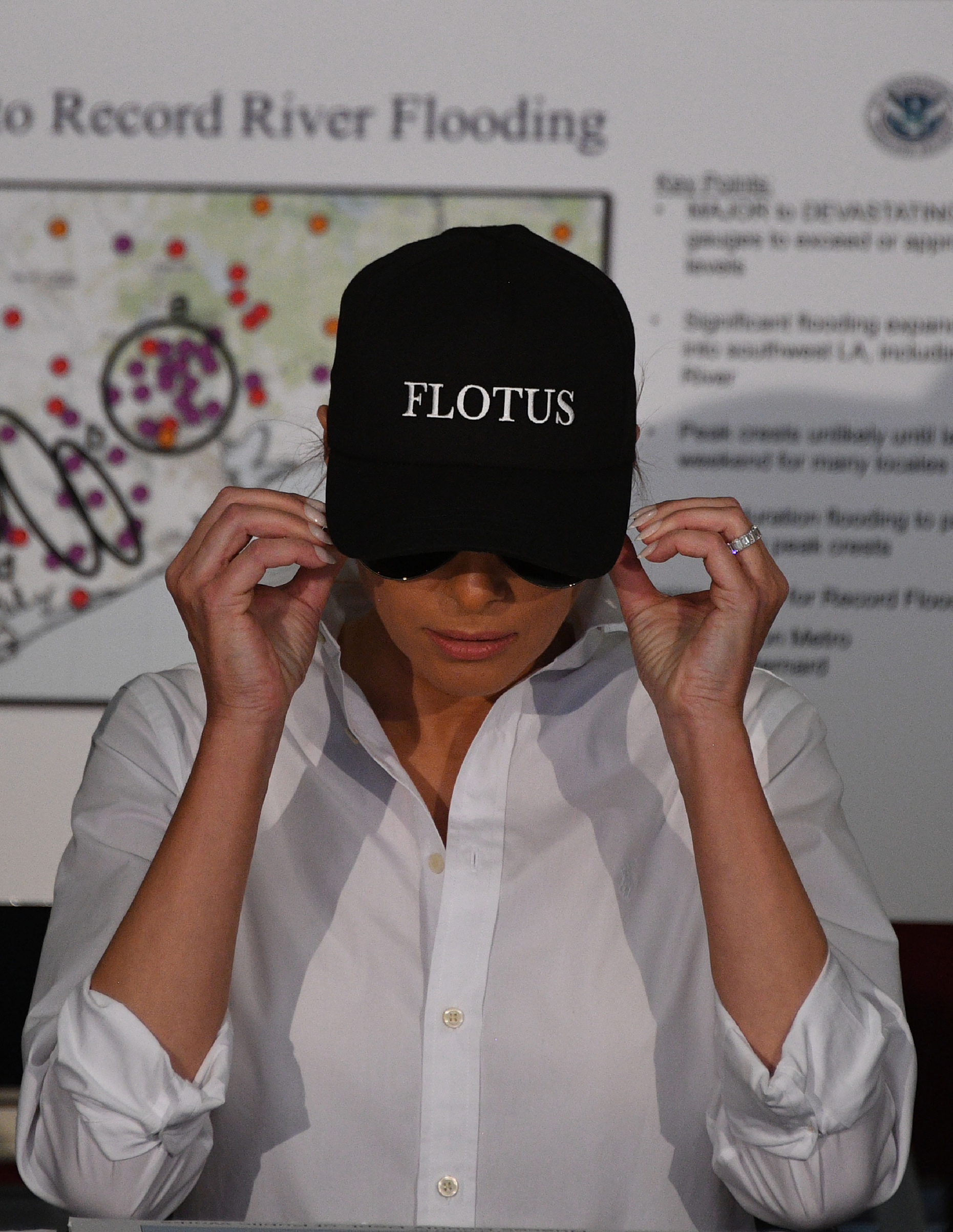 First lady Melania Trump wearing a cap that says  FLOTUS  listens during a firehouse briefing on Hurricane Harvey in Corpus Christi, Texas on Aug. 29, 2017.