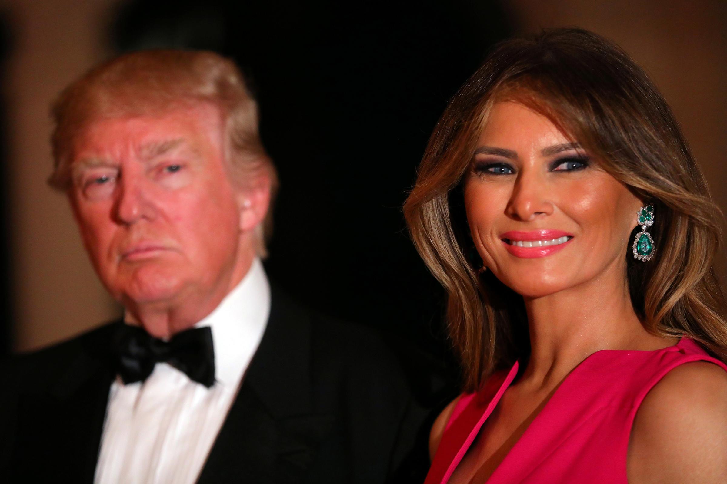 First Lady Melania Trump wearing bright pink Dior gown with emerald and diamond earrings, attends the 60th Annual Red Cross Gala at Mar-a-Lago club in Palm Beach, Fla, Feb. 4, 2017. p and First Lady Melania Trump attend the 60th Annual Red Cross Gala at Mar-a-Lago club in Palm Beach, Florida, U.S