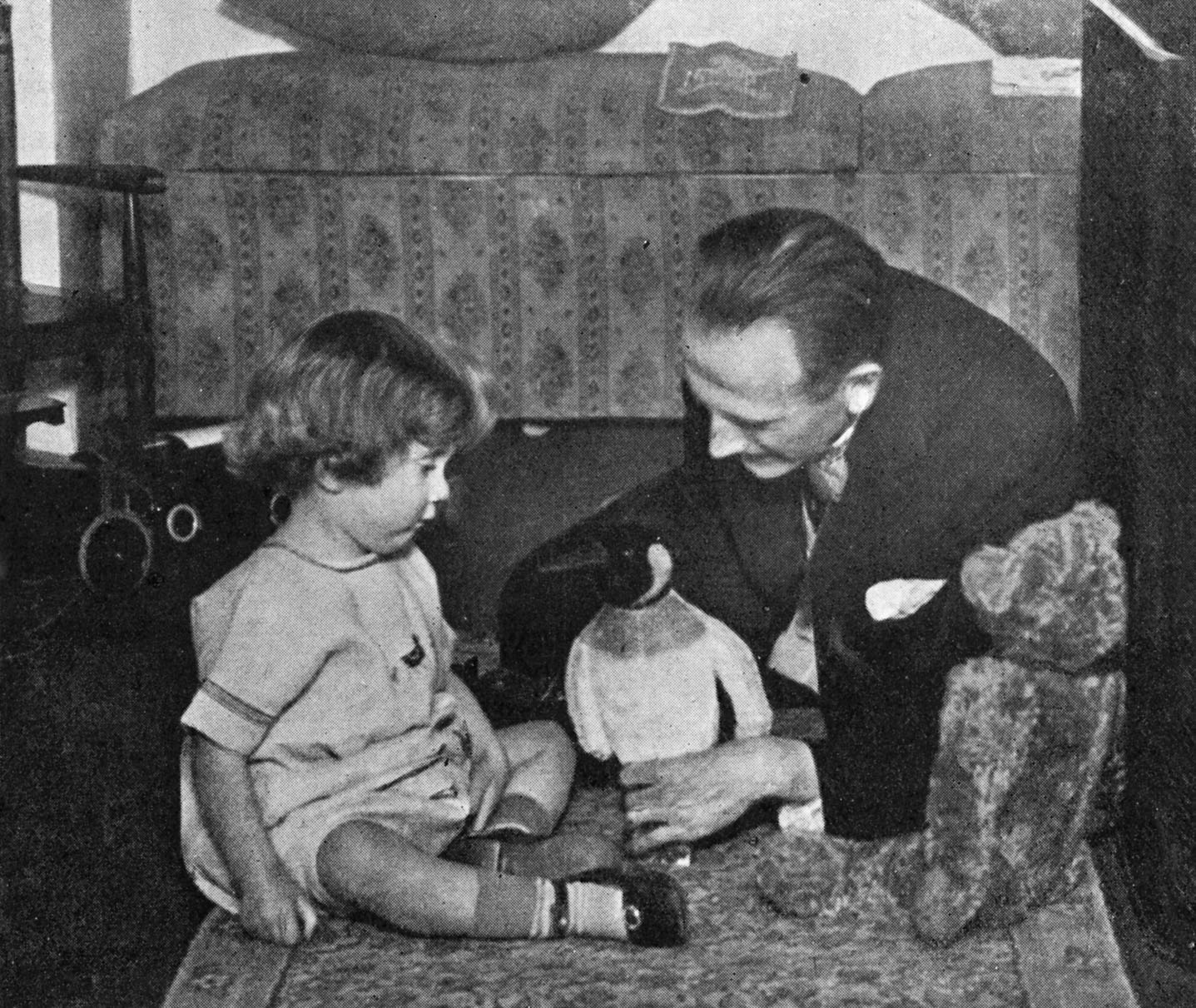 A. A. Milne and Christopher Robin Milne playing with a toy teddy bear. (Culture Club—Getty Images)