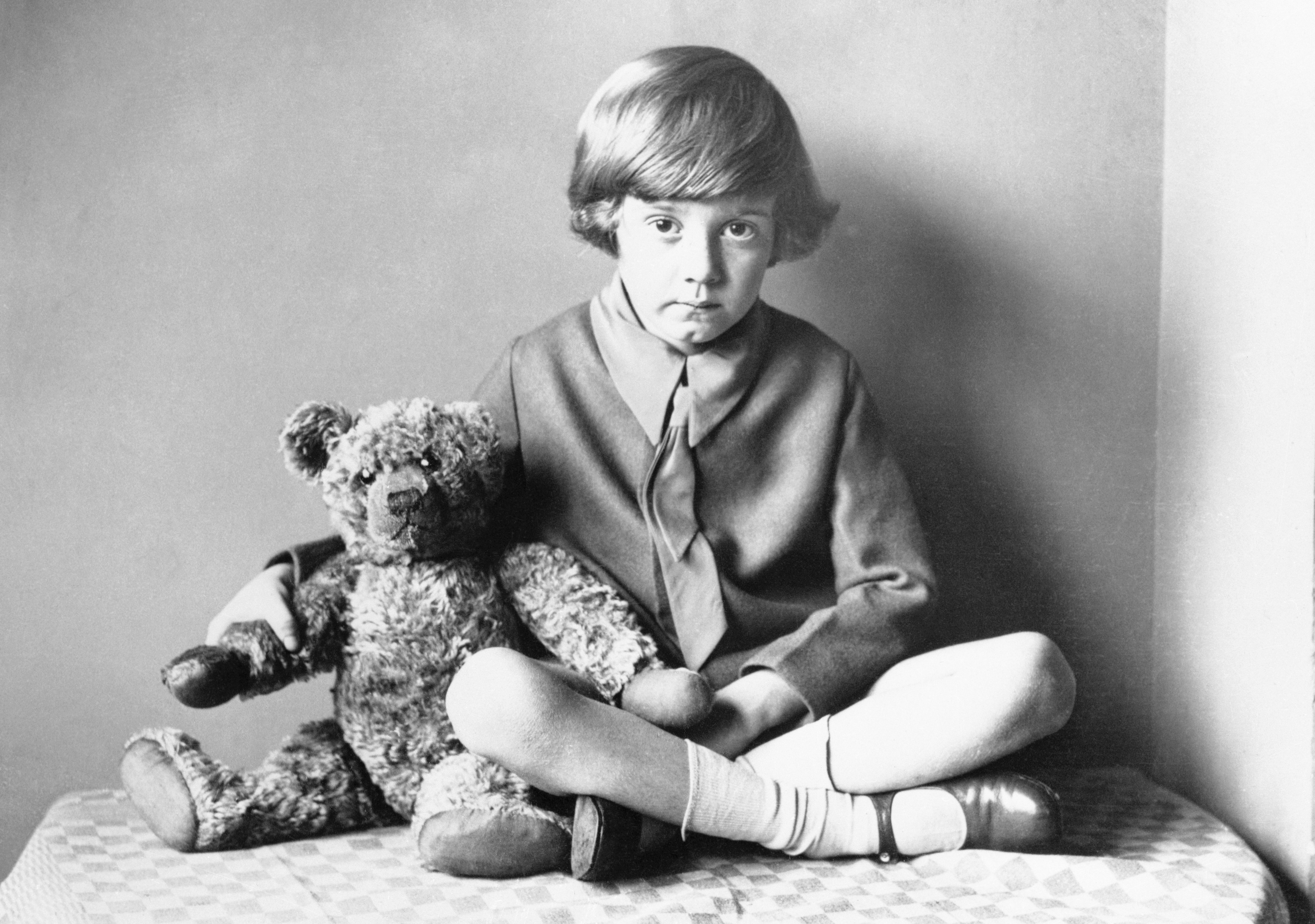 Winnie the Pooh Christopher Robin sitting at home with his teddy bear. (Bettmann—Bettmann Archive)