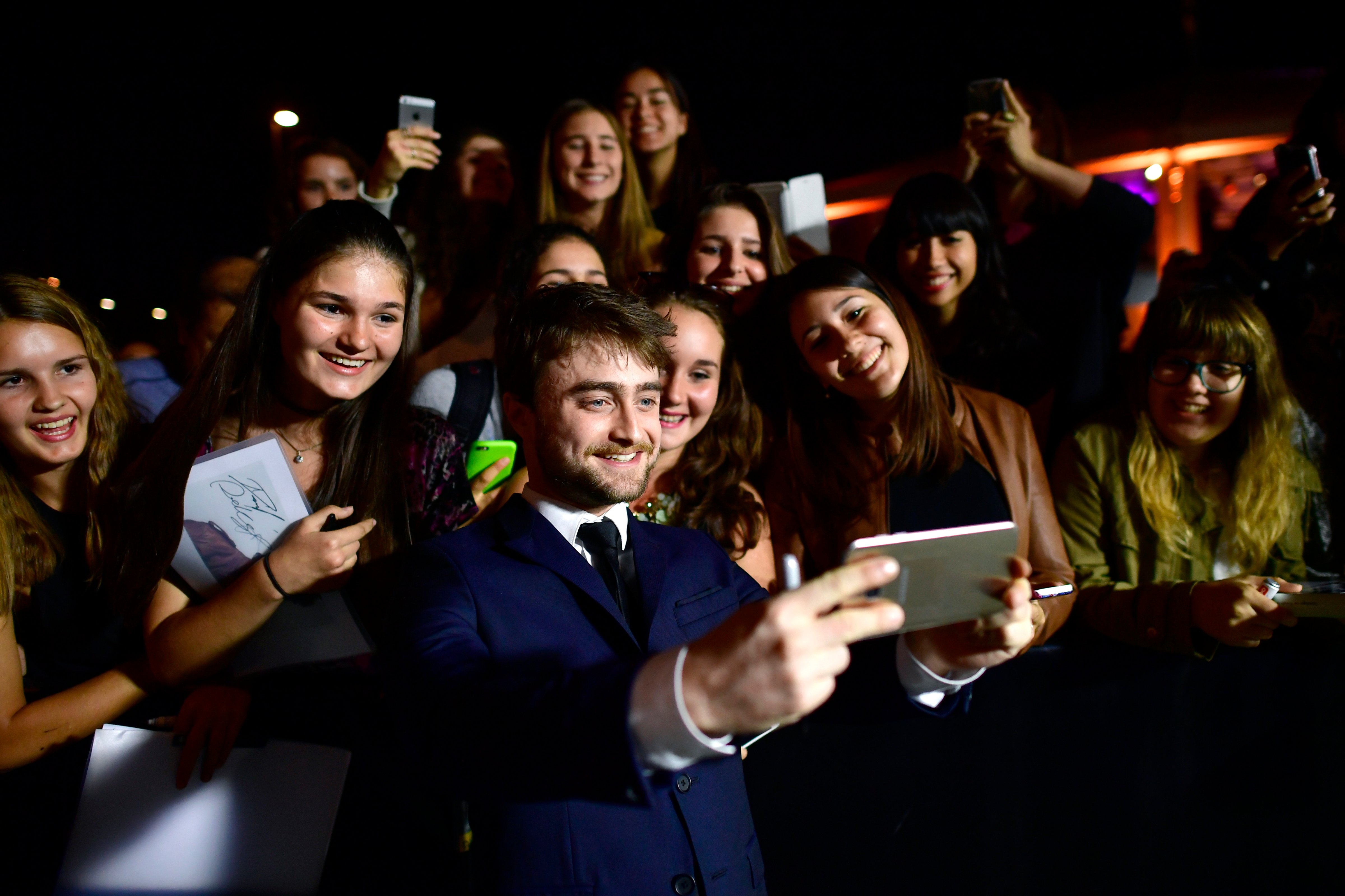 Daniel Radcliffe writes autographs and takes selfies with fans as he attends the 'Imperium' premiere during the 12th Zurich Film Festival on September 30, 2016 in Zurich, Switzerland. (Alexander Koerner—Getty Images)