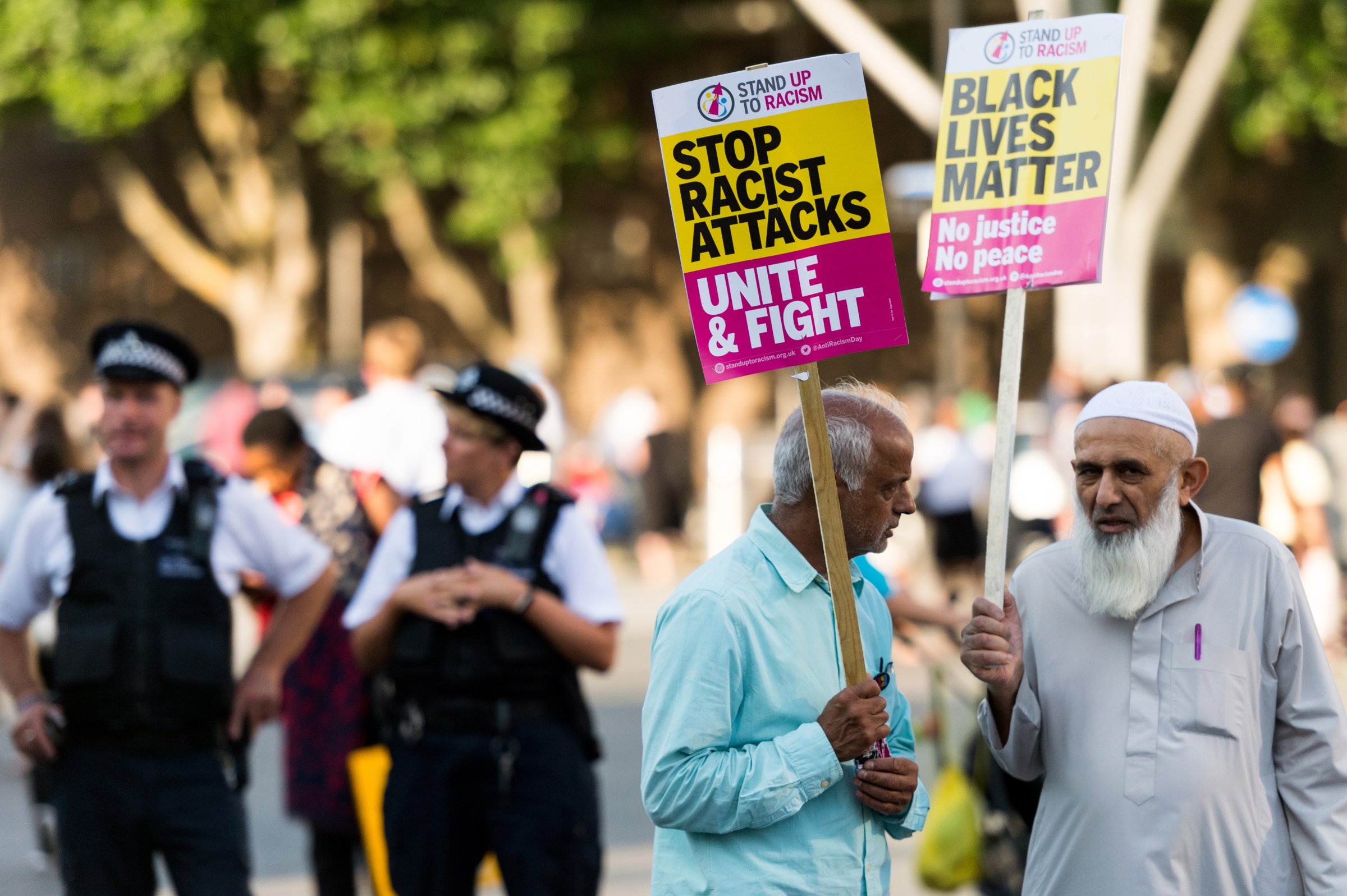 Protesters hold banners reading "Black Lives Matter - No Justice, No Peace - Stop Racist Attacks - Unite And Fight" at a vigil for Resham Khan and Janeel Muhktar who were attacked with sulphuric acid in London, United Kingdom on July 05, 2017.