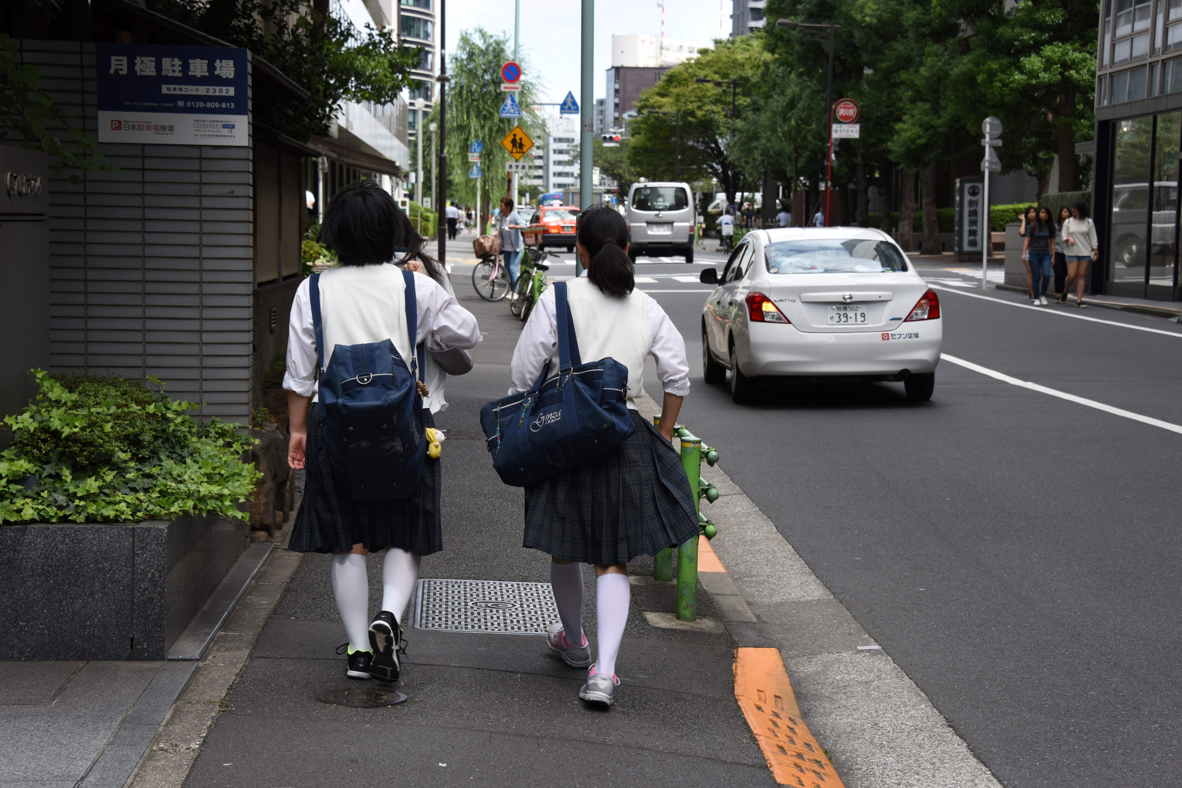 Japanese schoolgirls walk on a street in Tokyo on September 1, 2017. (Toru Yamanaka—AFP/Getty Images)