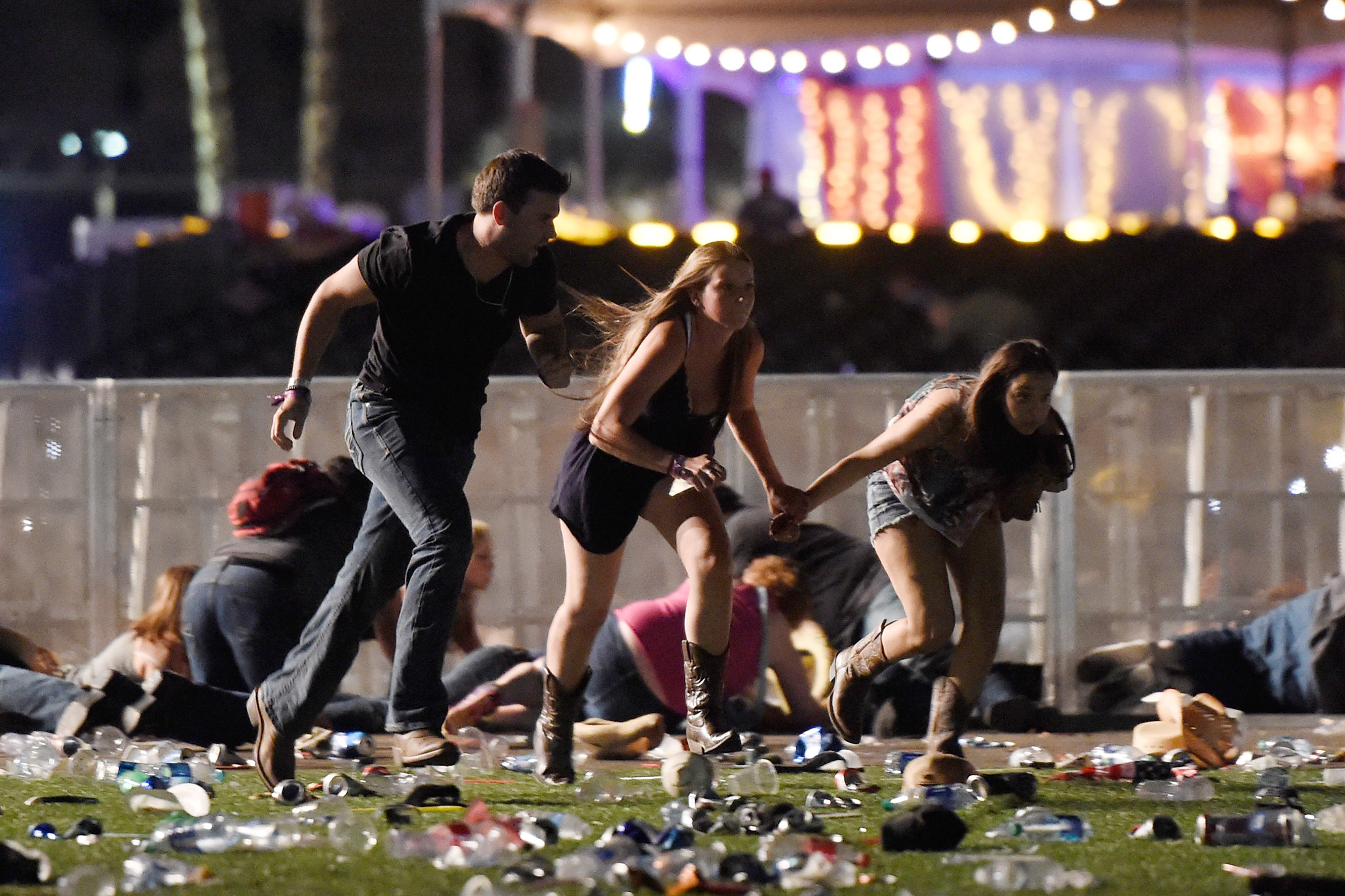 People run from the Route 91 Harvest country music festival after apparent gun fire was hear on October 1, 2017 in Las Vegas, Nevada. A gunman has opened fire on a music festival in Las Vegas, leaving at least 20 people dead and more than 100 injured. Police have confirmed that one suspect has been shot. The investigation is ongoing. (Photograph by David Becker—Getty)