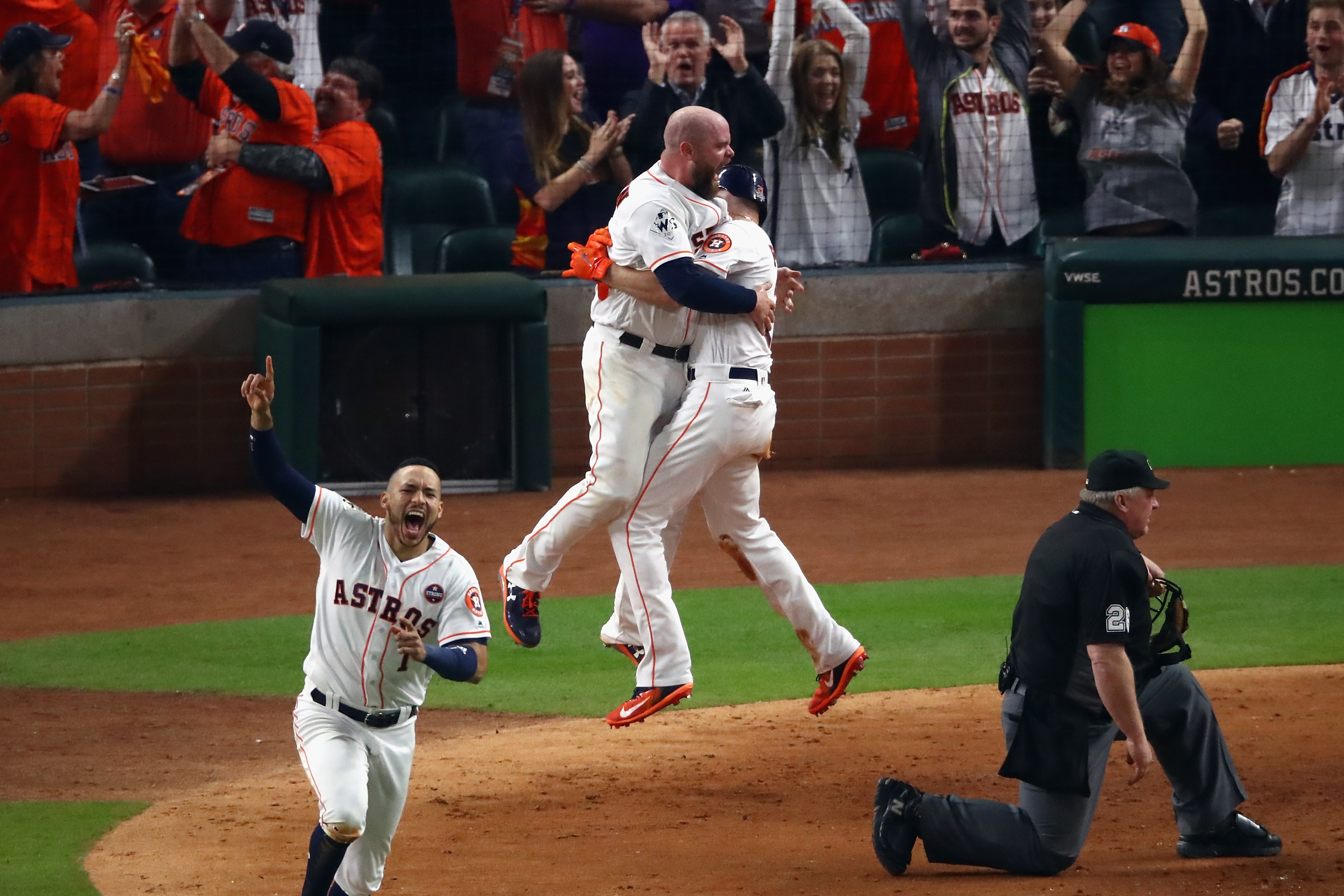Derek Fisher of the Houston Astros celebrates with Brian McCann after scoring the winning run during the tenth inning against the Los Angeles Dodgers in game five of the 2017 World Series in Houston, Texas on October 30, 2017. (Ezra Shaw—Getty Images)
