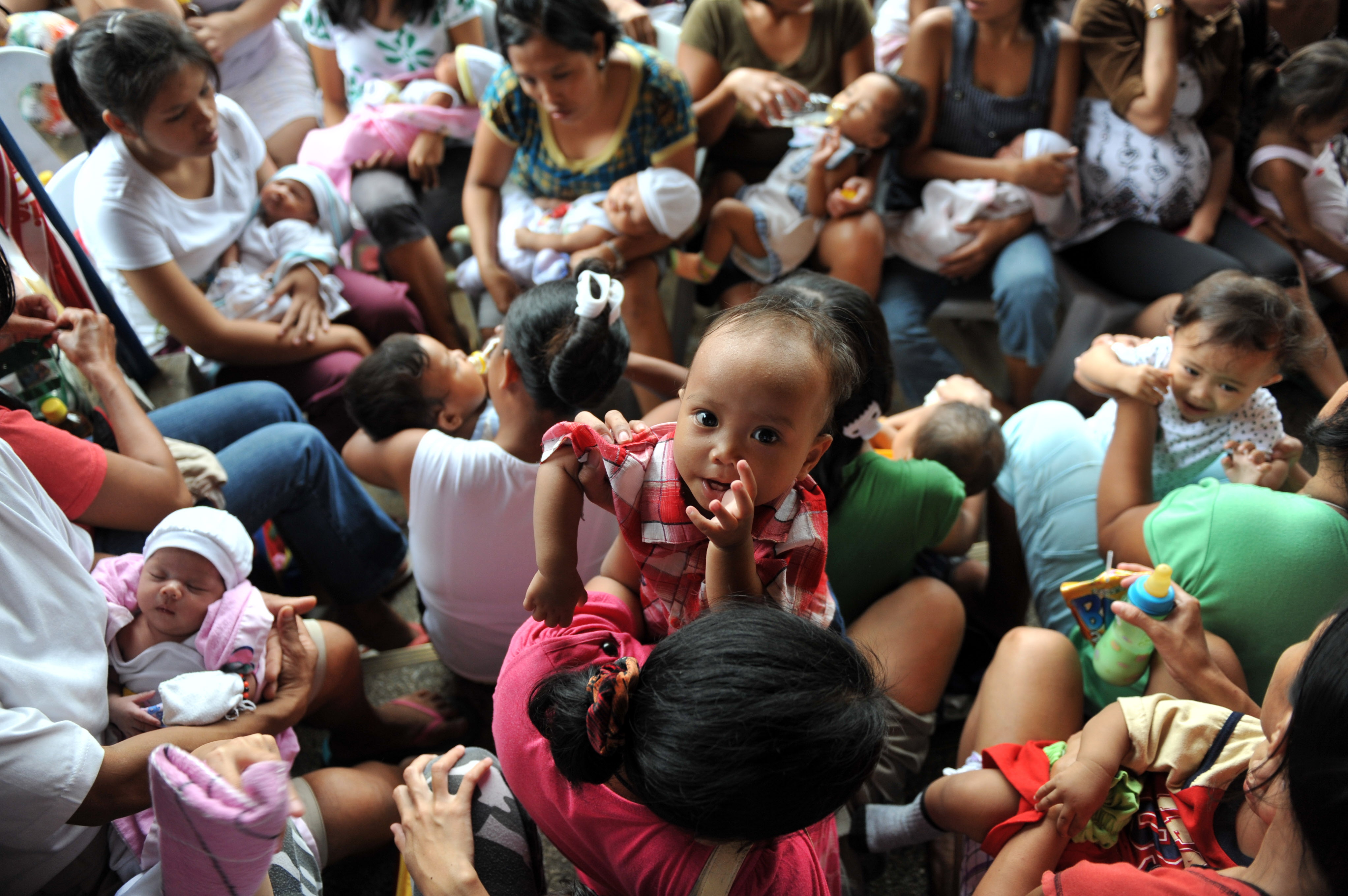 Pregnant women affected by floods wait for a check-up organized by the United Nations Population Fund (UNFPA) in Cainta, Philippines on Oct.8, 2009. (Ted Aljibe—AFP/Getty Images)