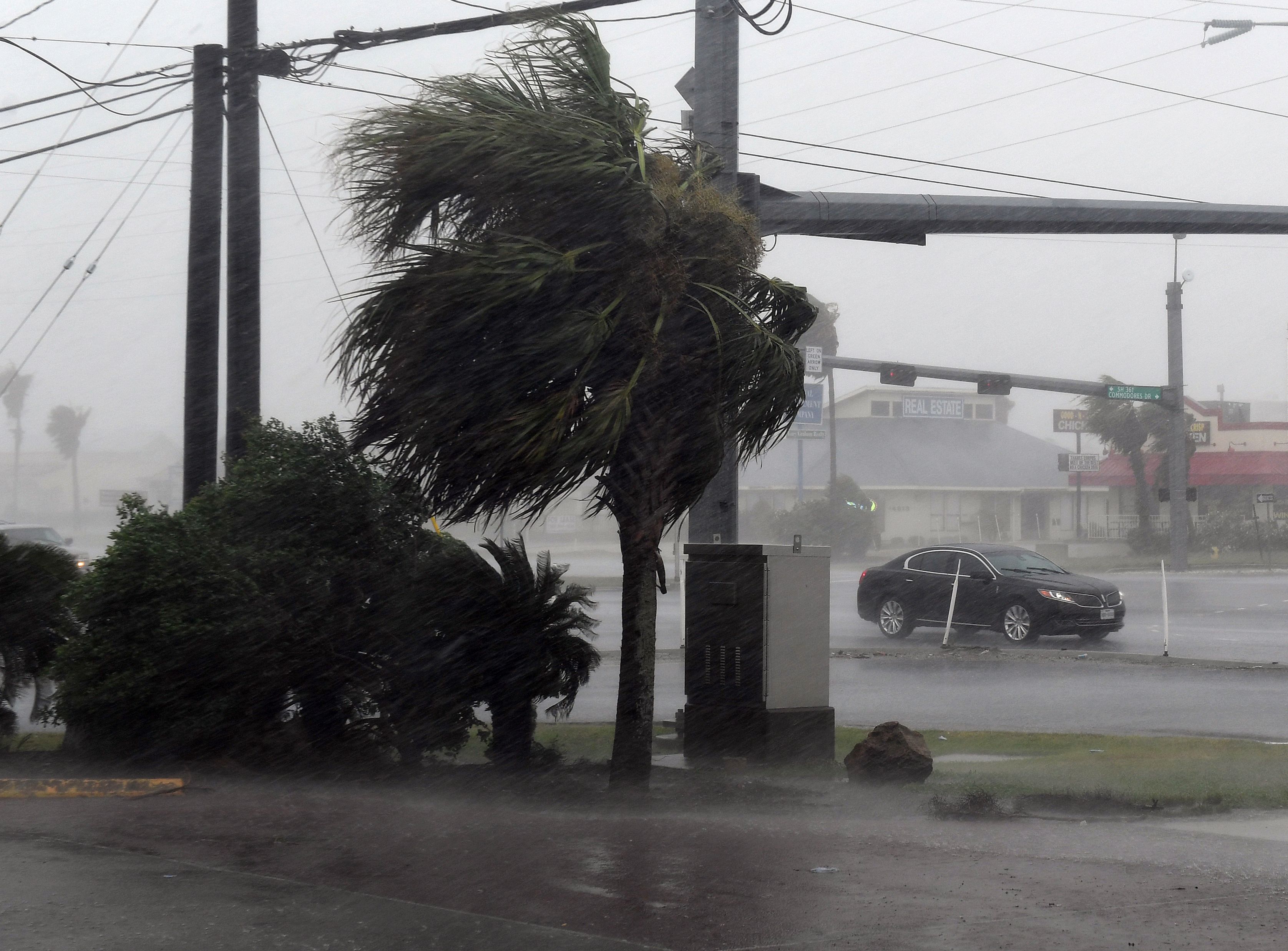 A motorist drives through heavy rain before the approaching Hurricane Harvey hits Corpus Christi, Texas on August 25, 2017.