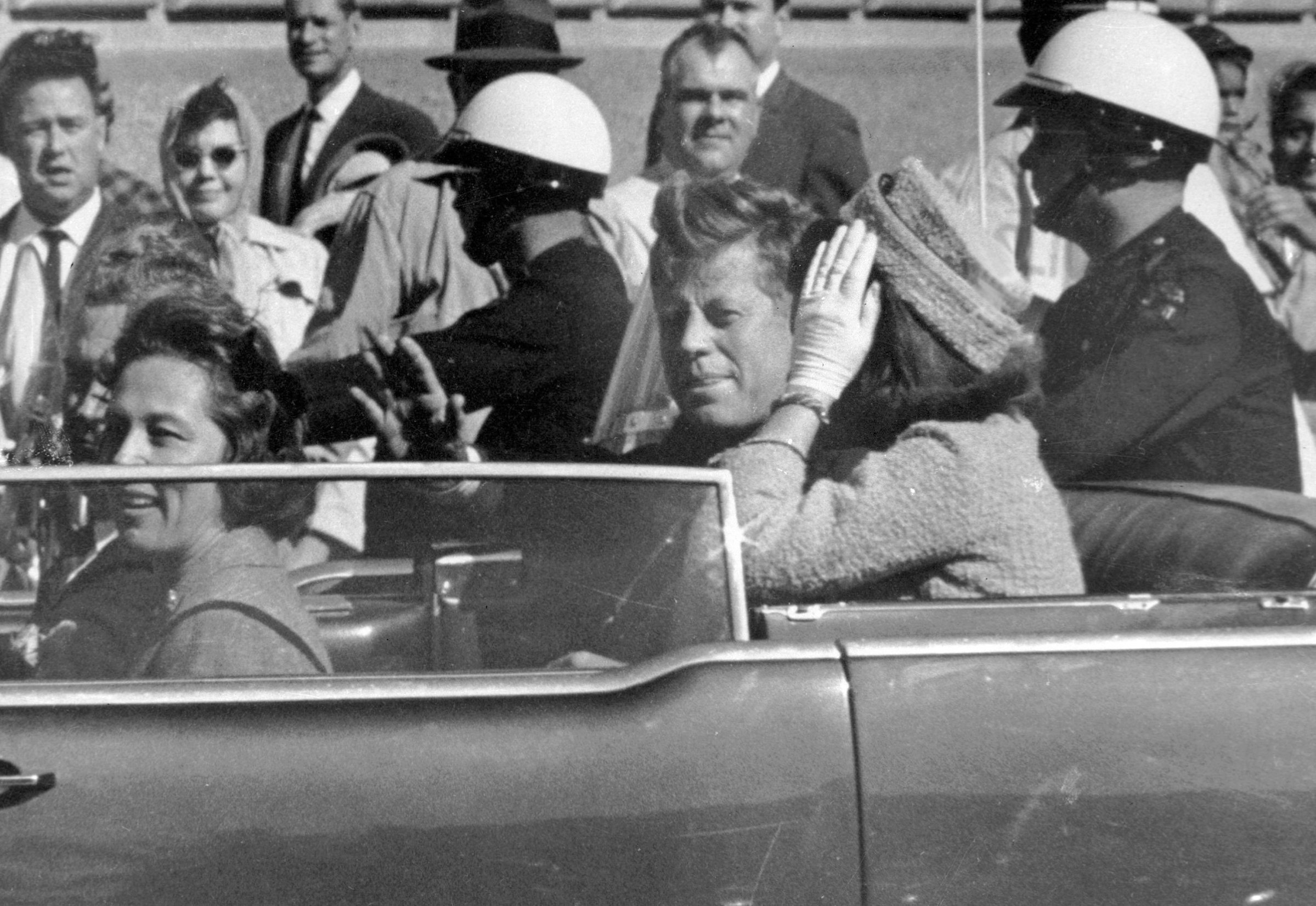 President John F. Kennedy waves from his car in a motorcade in Dallas on Nov. 22, 1963.