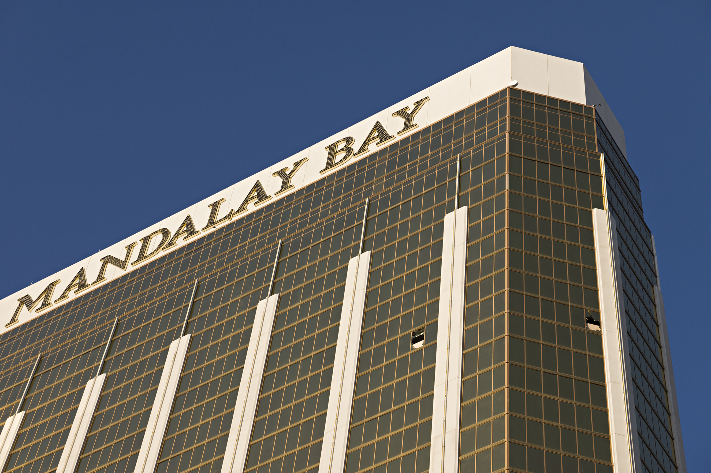 Broken windows on the 32nd floor of the Mandalay Bay Resort and Casino where a gunman opened fire on a concert crowd , Oct. 4, 2017.
