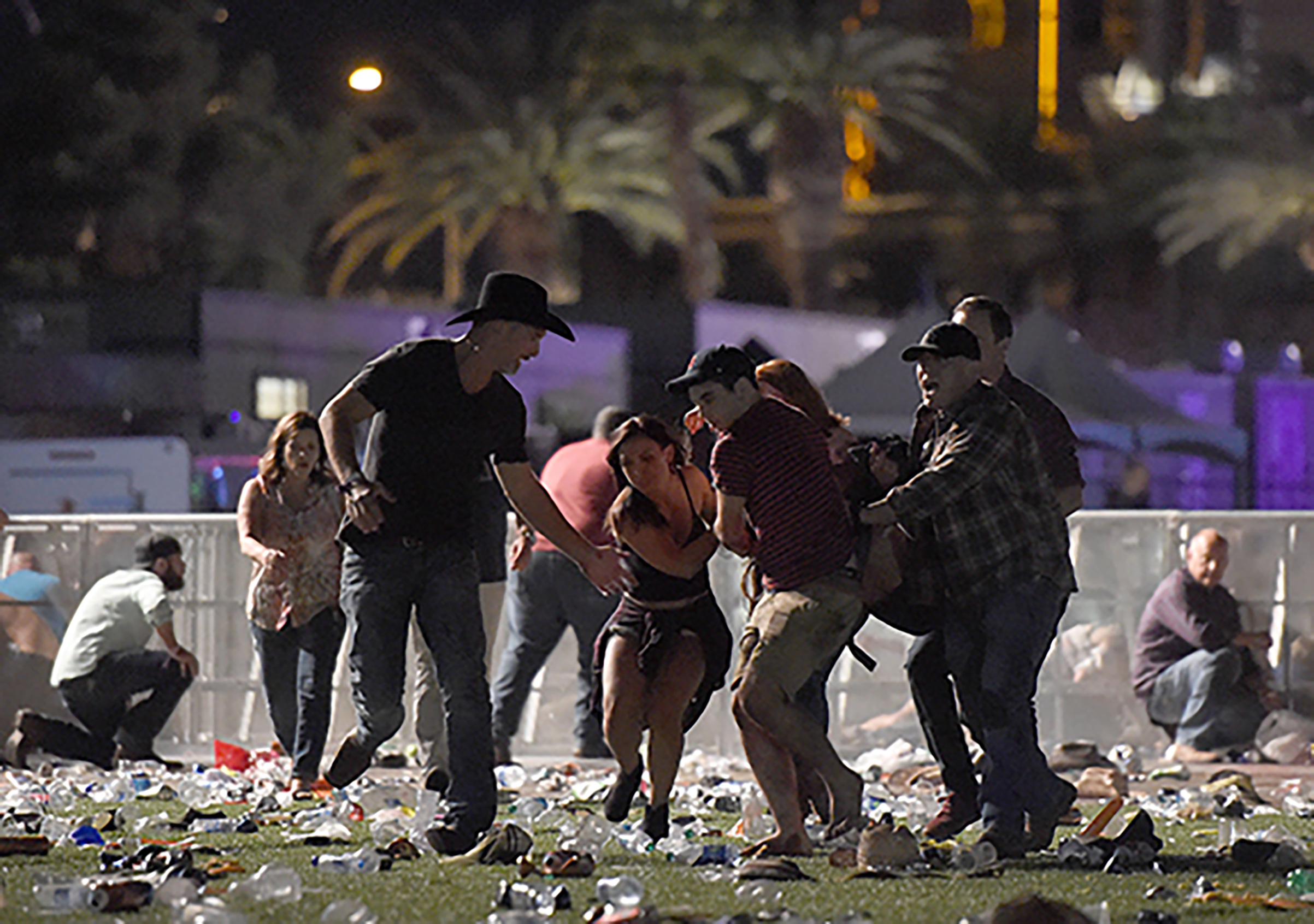 People carry a person after a shooting at the Route 91 Harvest country music festival after a shooting, Oct. 1, 2017 in Las Vegas.