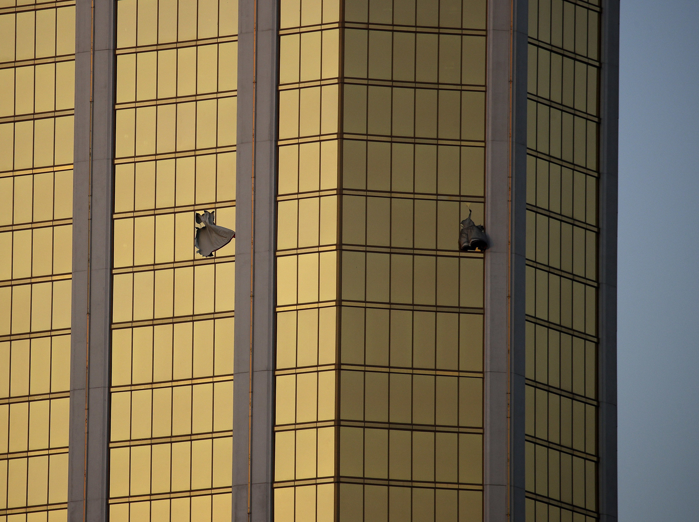 Drapes billow out of broken windows at the Mandalay Bay resort and casino, on the Las Vegas Strip following a deadly shooting at a music festival in Las Vegas on Oct 2, 2017.