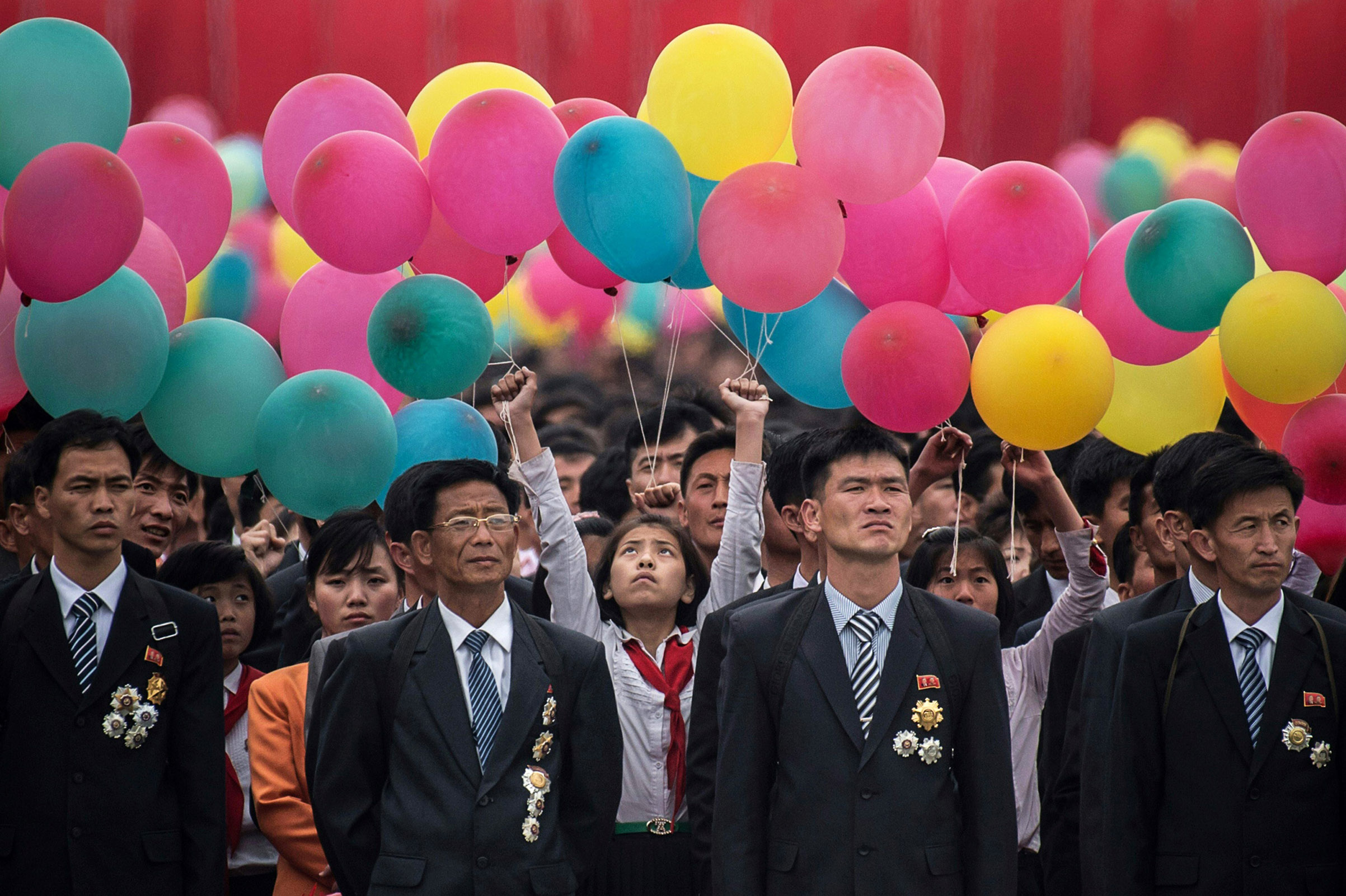 Participants wait to take part in a mass parade marking the end of the 7th Workers Party Congress in Kim Il Sung Square in Pyongyang on May 10, 2016. (Ed Jones—AFP/Getty Images)