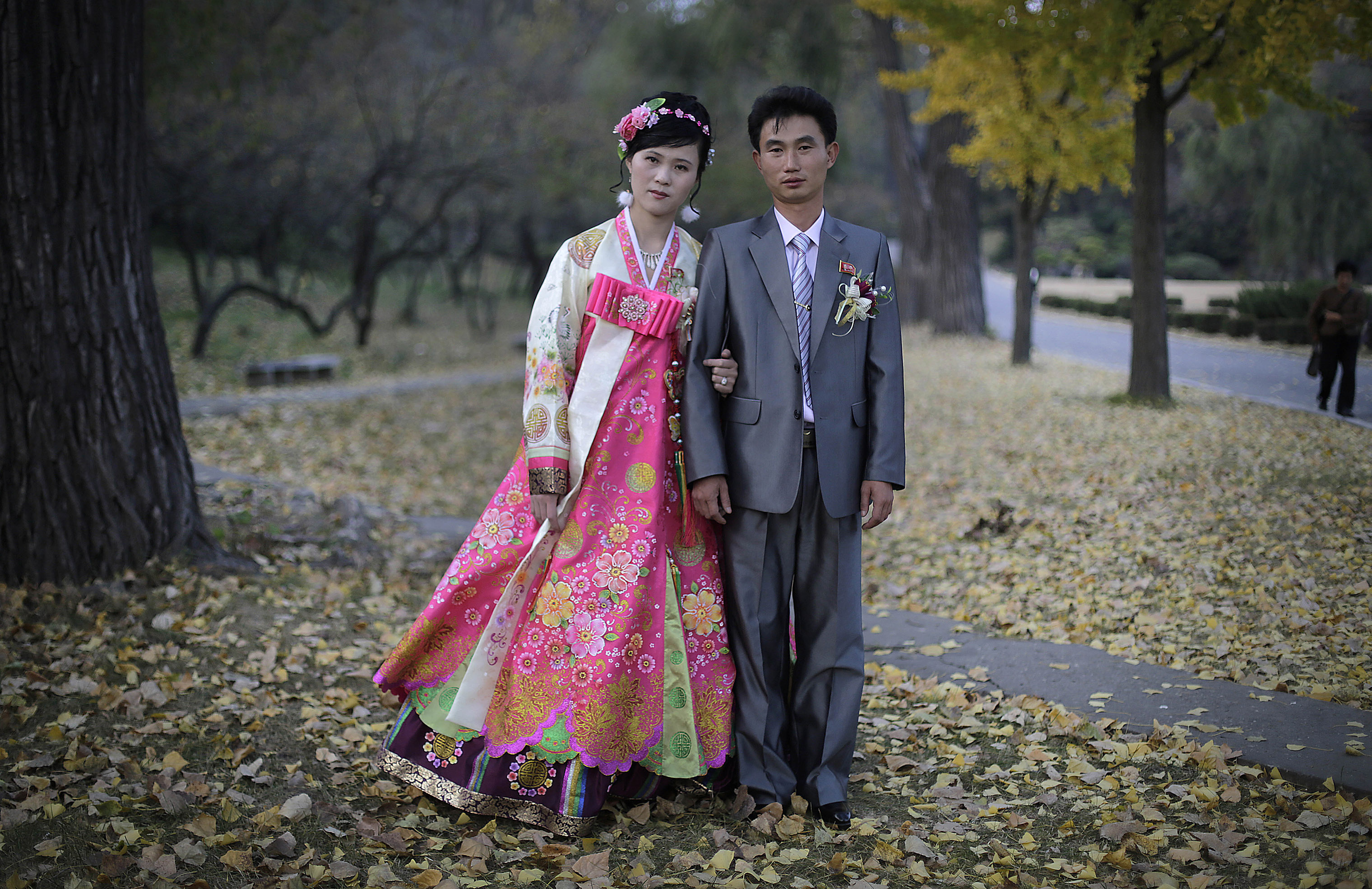 A bride and groom pose for a photograph at the hill where they went to take wedding pictures in Pyongyang on Oct. 25, 2014. (Wong Maye-E—AP/Shutterstock)