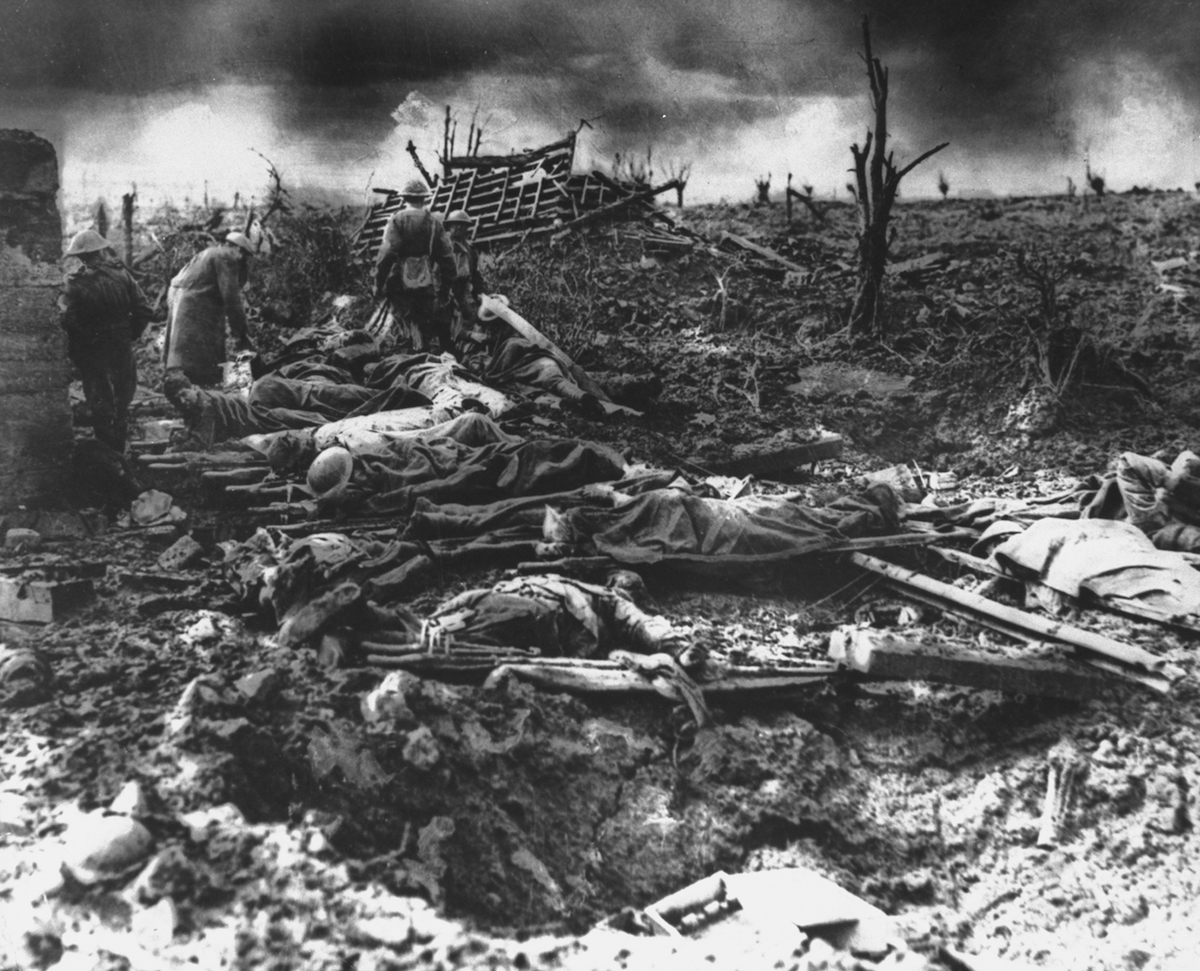 Dawn rising on muddy, horrific battlefield of Passchendaele as soldiers tend to the dead during WWI. (Time Life Pictures / The LIFE Picture Collection / Getty Images)