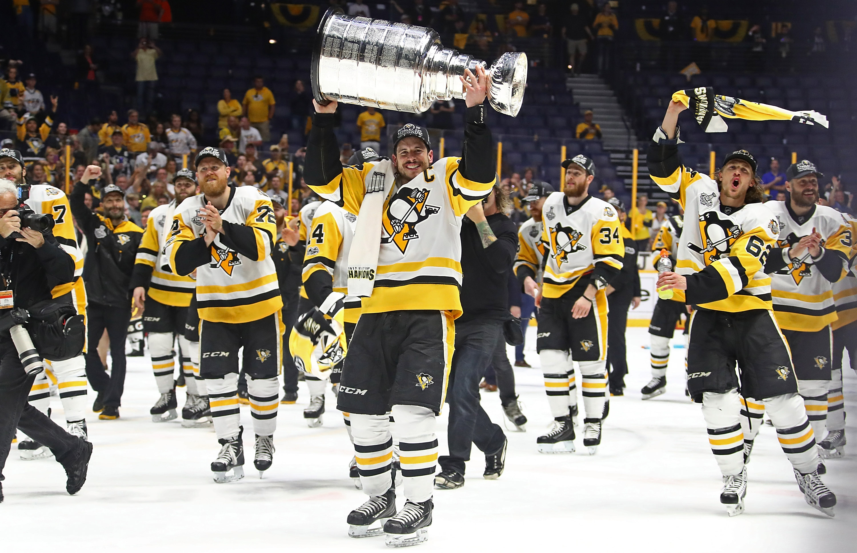 Sidney Crosby #87 of the Pittsburgh Penguins and his teammates celebrate with the Stanley Cup trophy after defeating the Nashville Predators 2-0 in Game Six of the 2017 NHL Stanley Cup Final at the Bridgestone Arena on June 11, 2017 in Nashville, Tennessee. (Frederick Breedon&mdash;Getty Images)