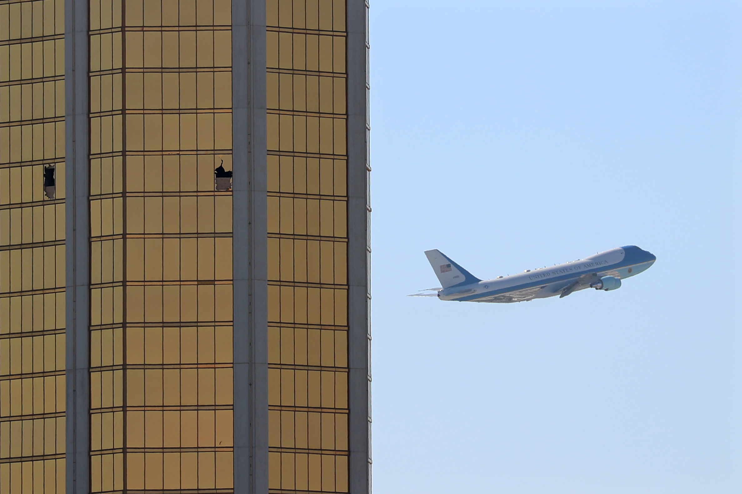 Air Force One departs Las Vegas past the broken windows on the Mandalay Bay hotel, where shooter Stephen Paddock conducted his mass shooting along the Las Vegas Strip on Oct. 4, 2017. (Mike Blake—Reuters)