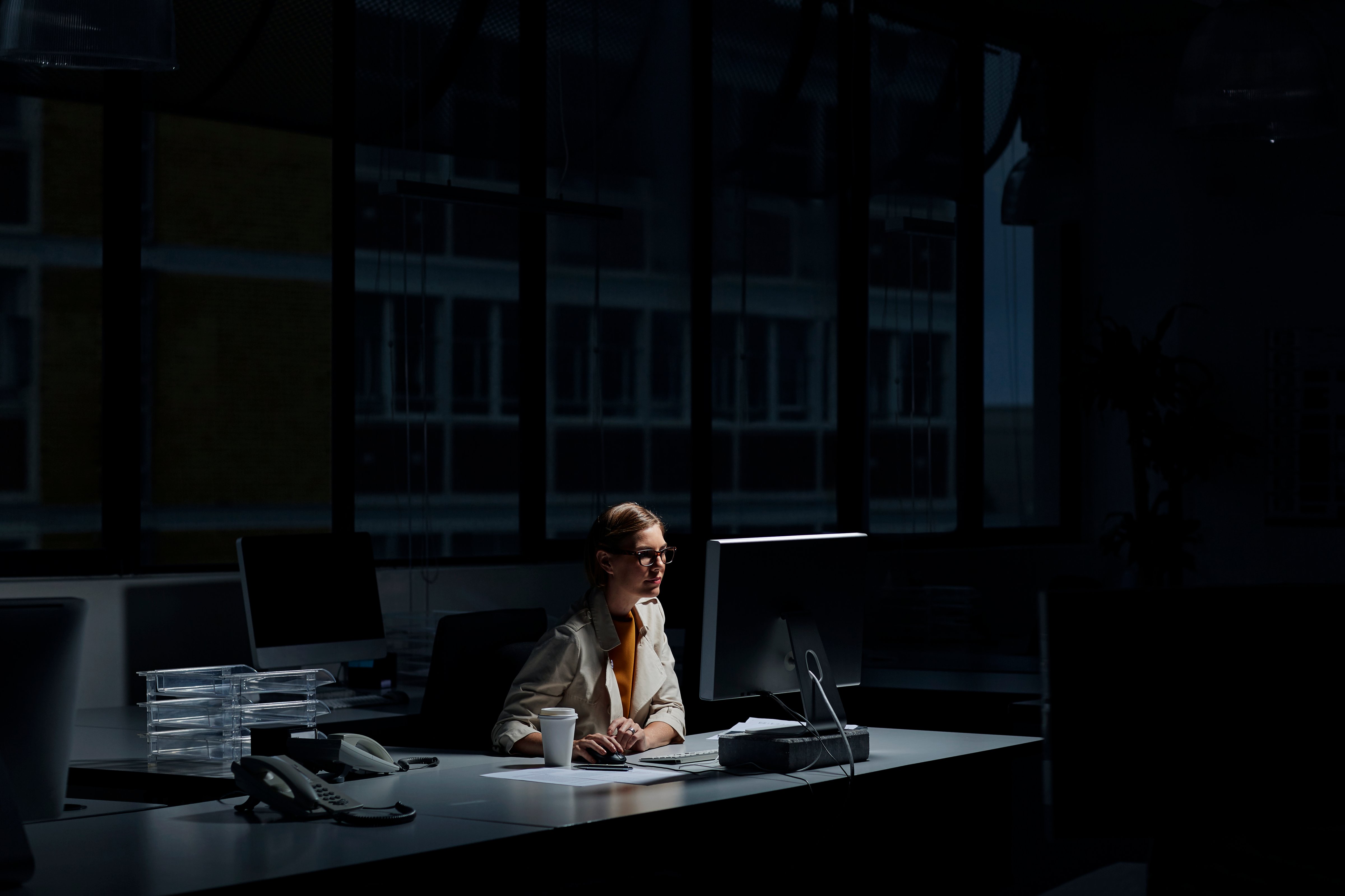 Young businesswoman using computer in dark office (Morsa Images&mdash;Getty Images)