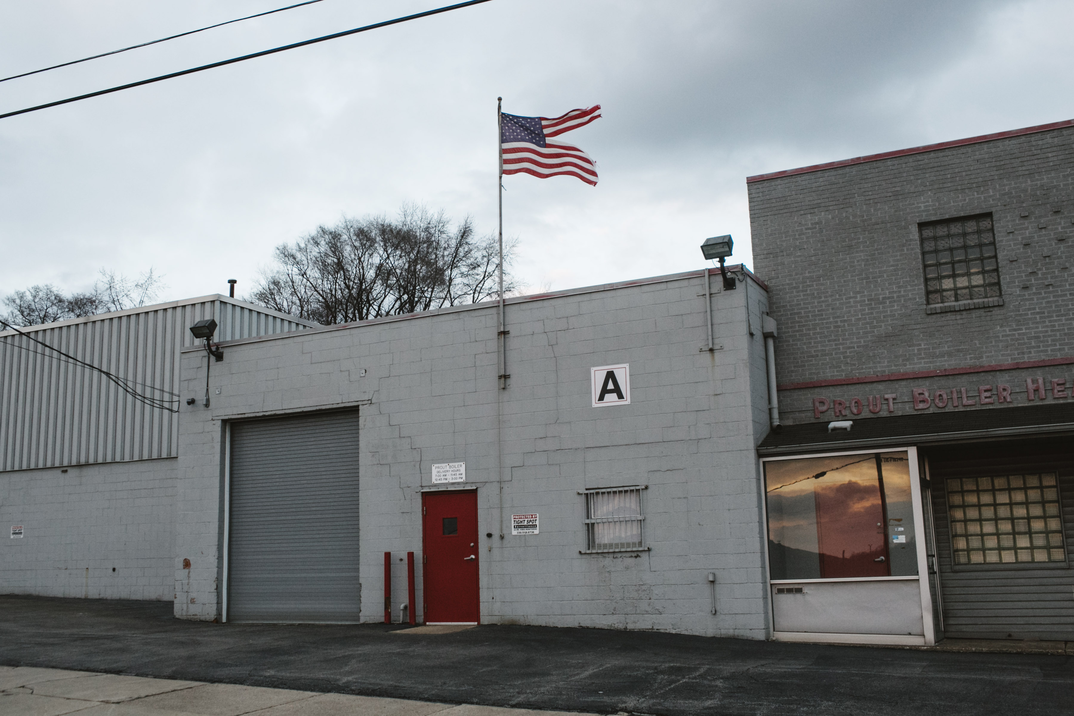 A tattered American flag flies over a heating business in Youngstown, Ohio on March 2, 2017. (Andrew Spear—The Washington Post/Getty Images)