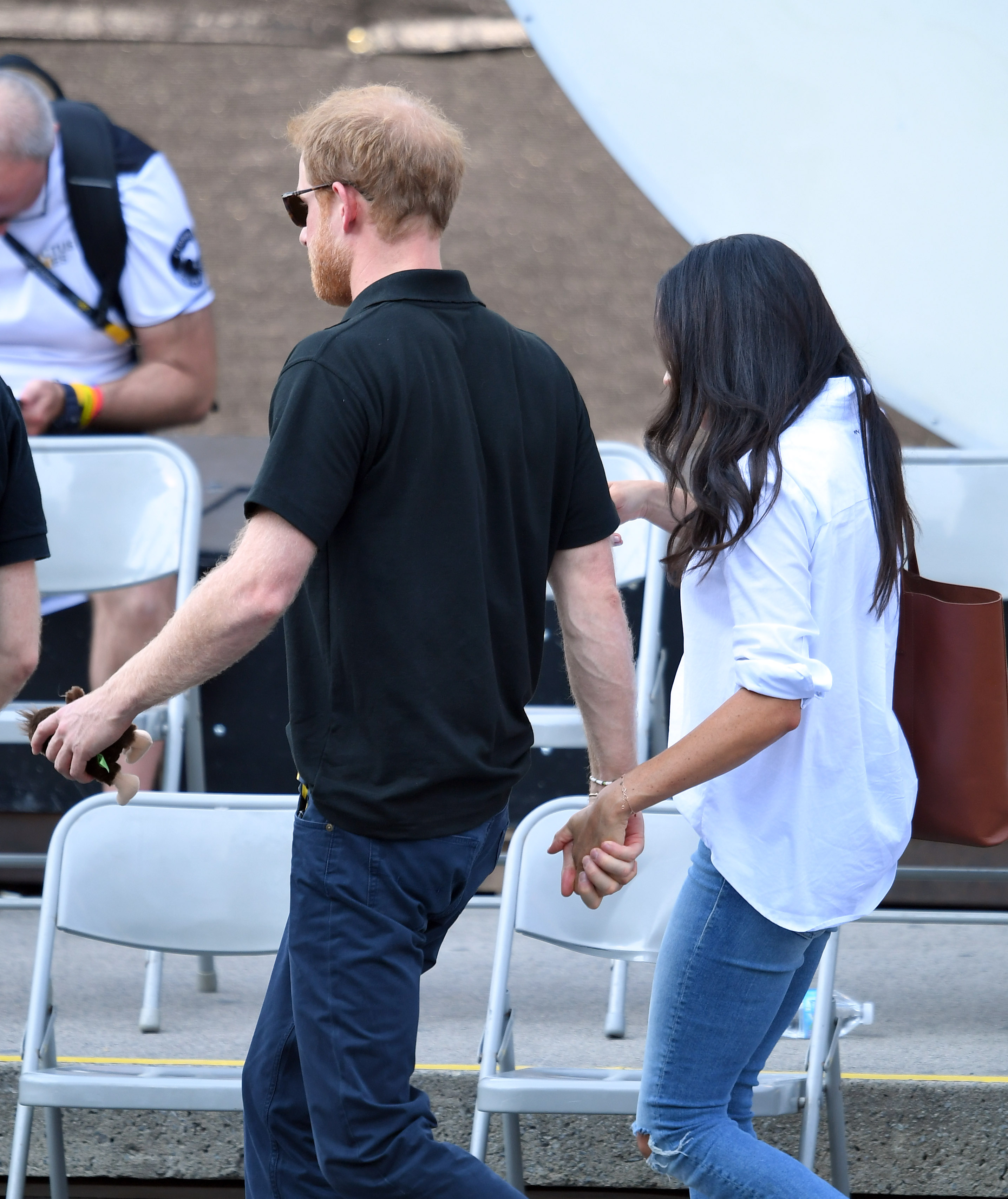 Meghan Markle and Prince Harry hold hands on day 3 of the Invictus Games Toronto 2017 on September 25, 2017 in Toronto, Canada. (Karwai Tang—WireImage)