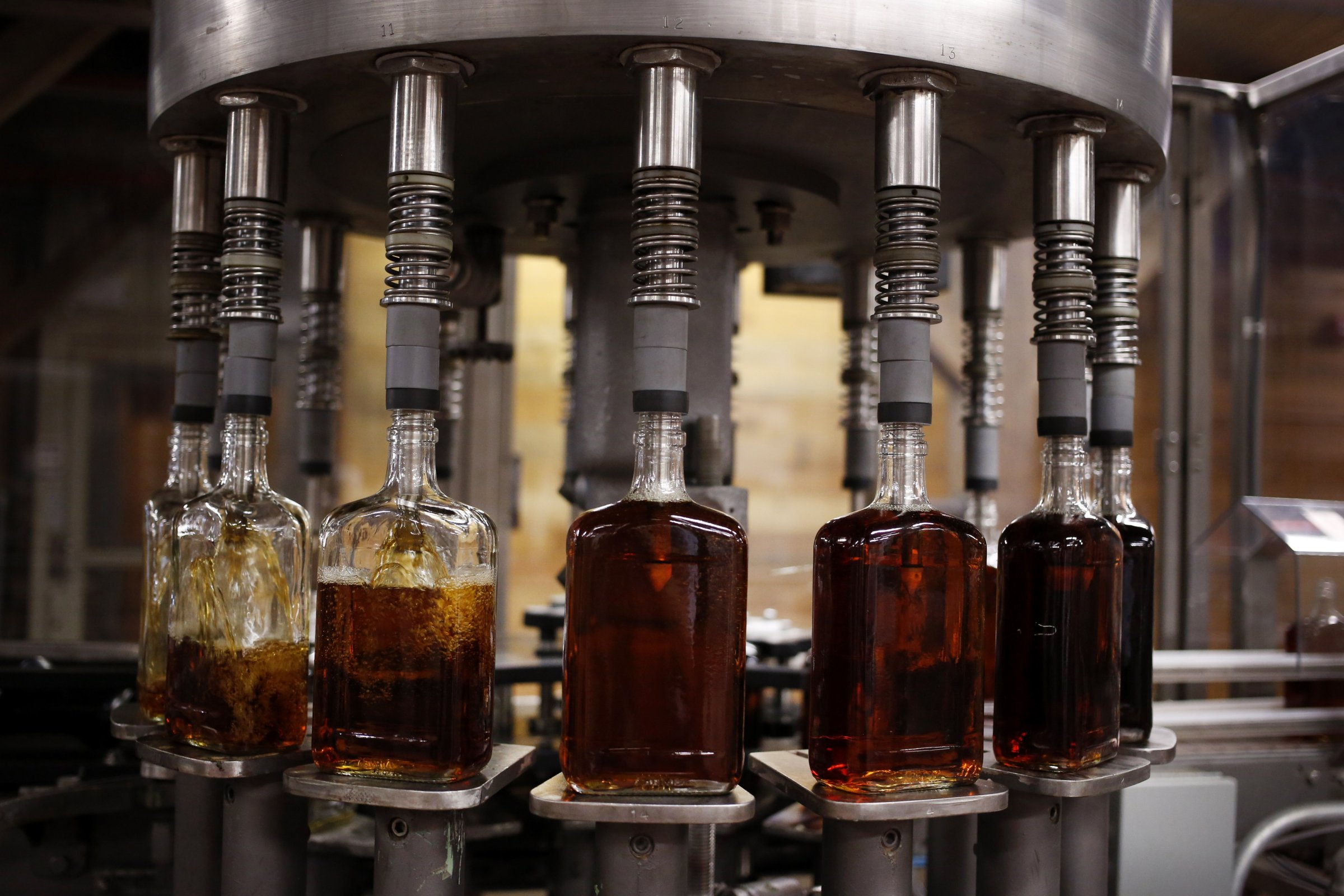 Bottles of single barrel bourbon are filled on a bottling line