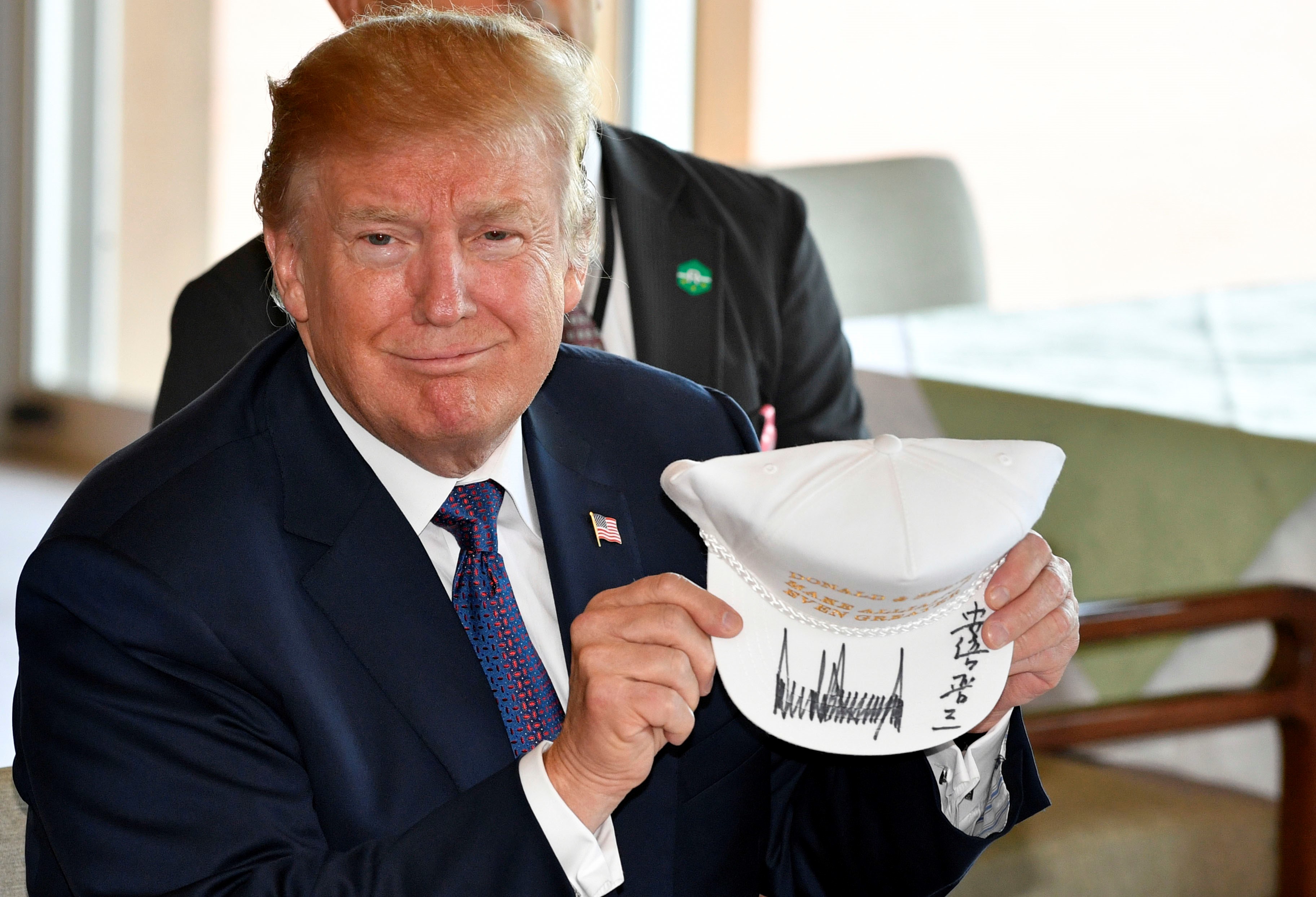 President Donald Trump shows off a signed hat during his meeting with Japanese Prime Minister Shinzo Abe at the Kasumigaseki Country Club on Nov. 05, 2017. (Franck Robichon—Anadolu Agency/Getty Images)
