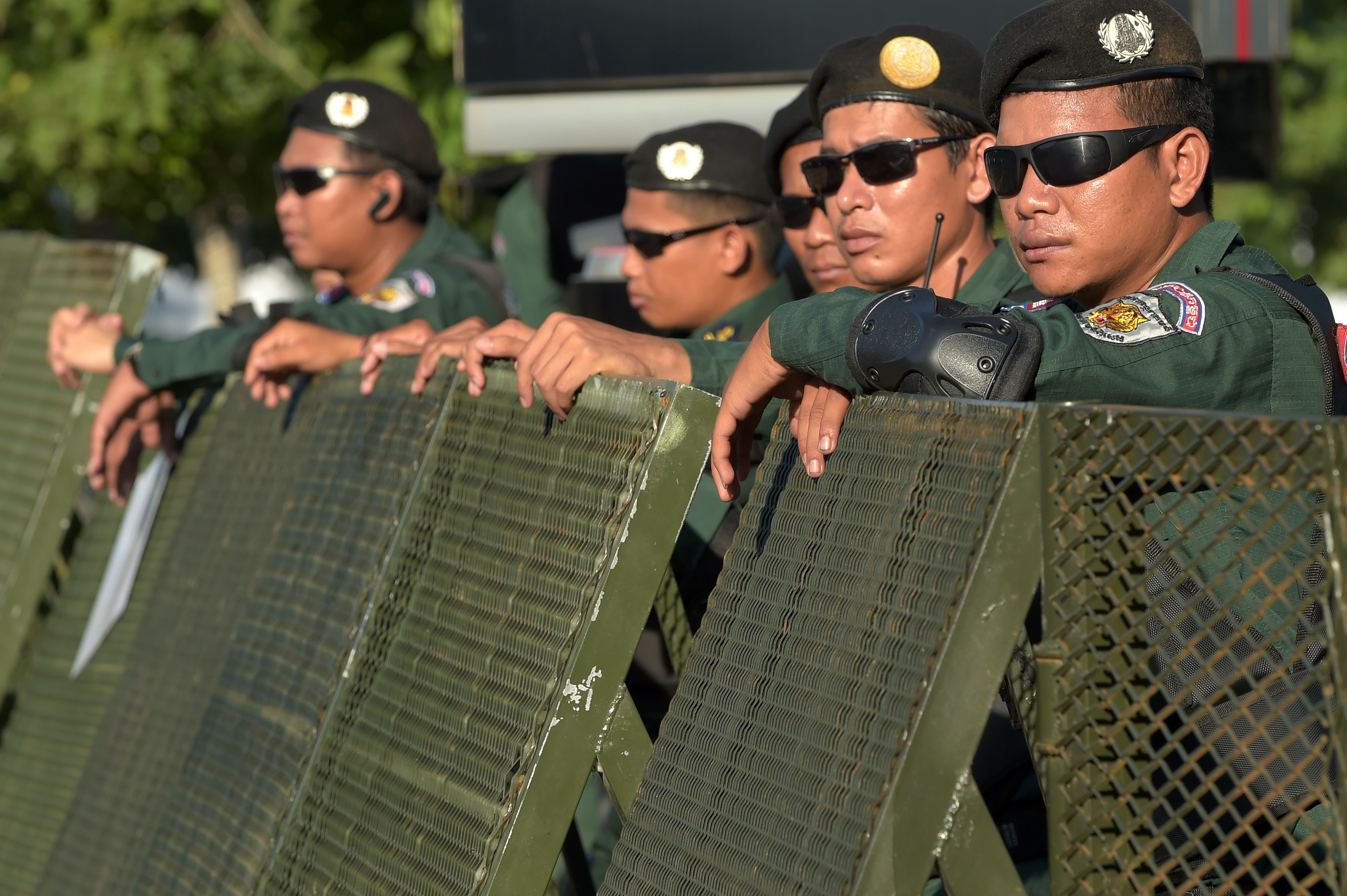 Cambodian police officials block a street during a hearing at the Supreme Court in Phnom Penh on November 16, 2017.
                      Cambodian police locked down streets around the Supreme Court on November 16 ahead of an expected ruling on the dissolution of the country's main opposition party, a move rights groups warn would strip 2018 elections of any credibility. / AFP PHOTO / TANG CHHIN SOTHY        (Photo credit should read TANG CHHIN SOTHY/AFP/Getty Images) (Tang Chhin Sothy—AFP/Getty Images)