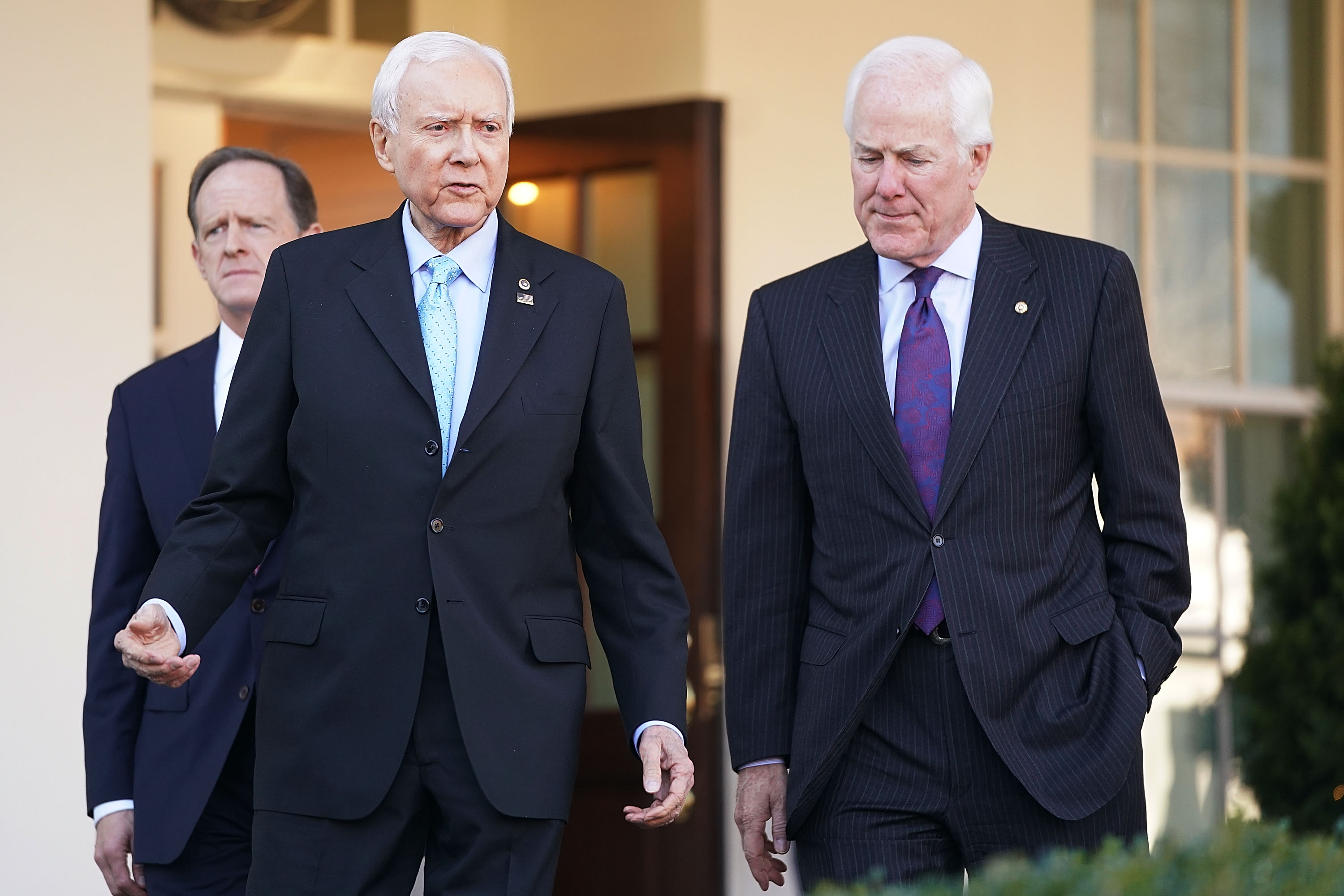 Senate Finance Committee members Sen. Pat Toomey (R-PA) (L) and Sen. John Cornyn (R-TX) (R) walk out of the West Wing with Chairman Orrin Hatch (R-UT) following a lunch meeting with U.S. President Donald Trump at the White House November 27, 2017 in Washington, DC. (Chip Somodevilla—Getty Images)