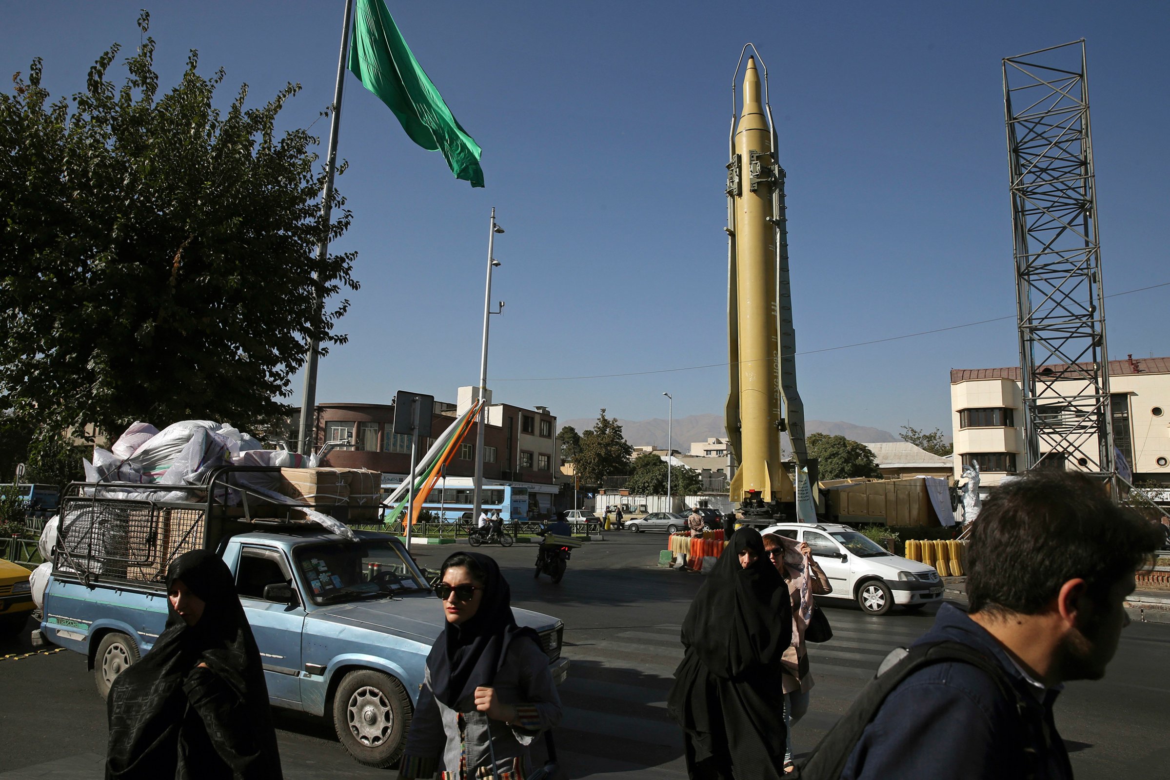 Iranians walk past a Ghadr-F missile displayed at a Revolutionary Guard hardware exhibition, marking 36th anniversary of the outset of Iran-Iraq war, in downtown Tehran on Sept. 25, 2016.