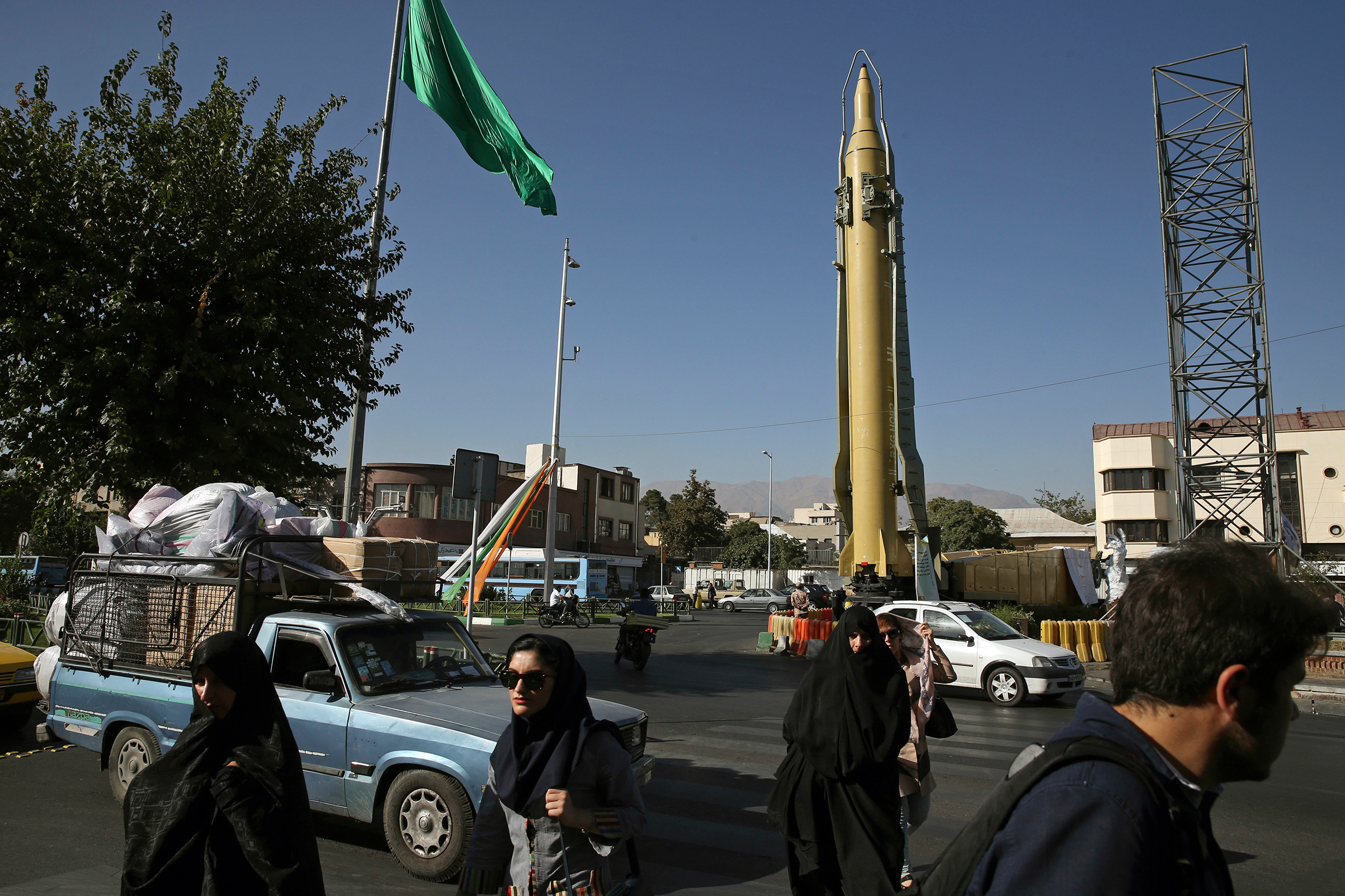 Iranians walk past a Ghadr-F missile displayed at a Revolutionary Guard hardware exhibition, marking 36th anniversary of the outset of Iran-Iraq war, in downtown Tehran on Sept. 25, 2016. (Vahid Salemi—AP/REX/Shutterstock)
