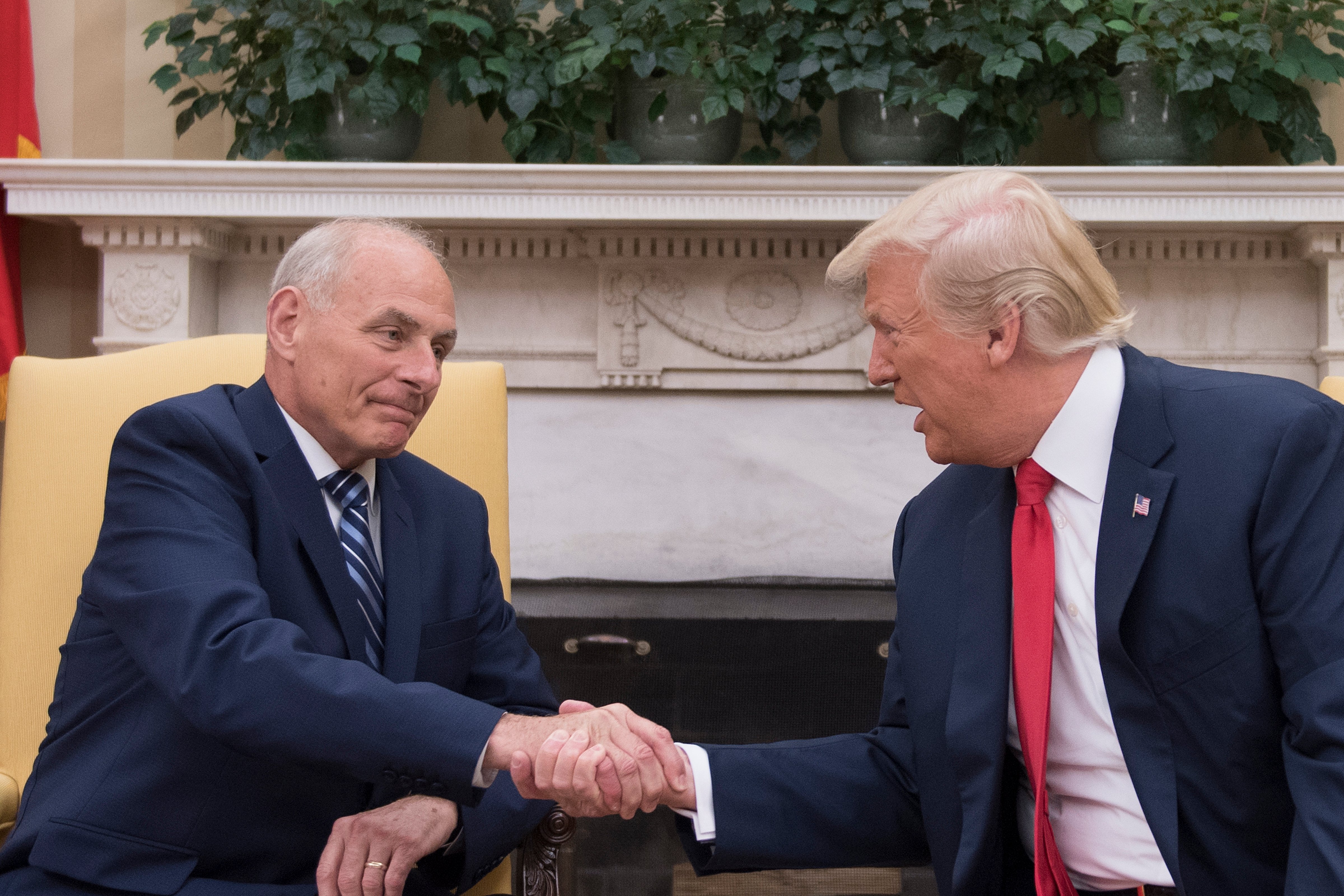 President Donald Trump (R) shakes hands with newly sworn-in White House Chief of Staff John Kelly at the White House in Washington, D.C., on July 31, 2017. (Jim Watson—AFP/Getty Images)
