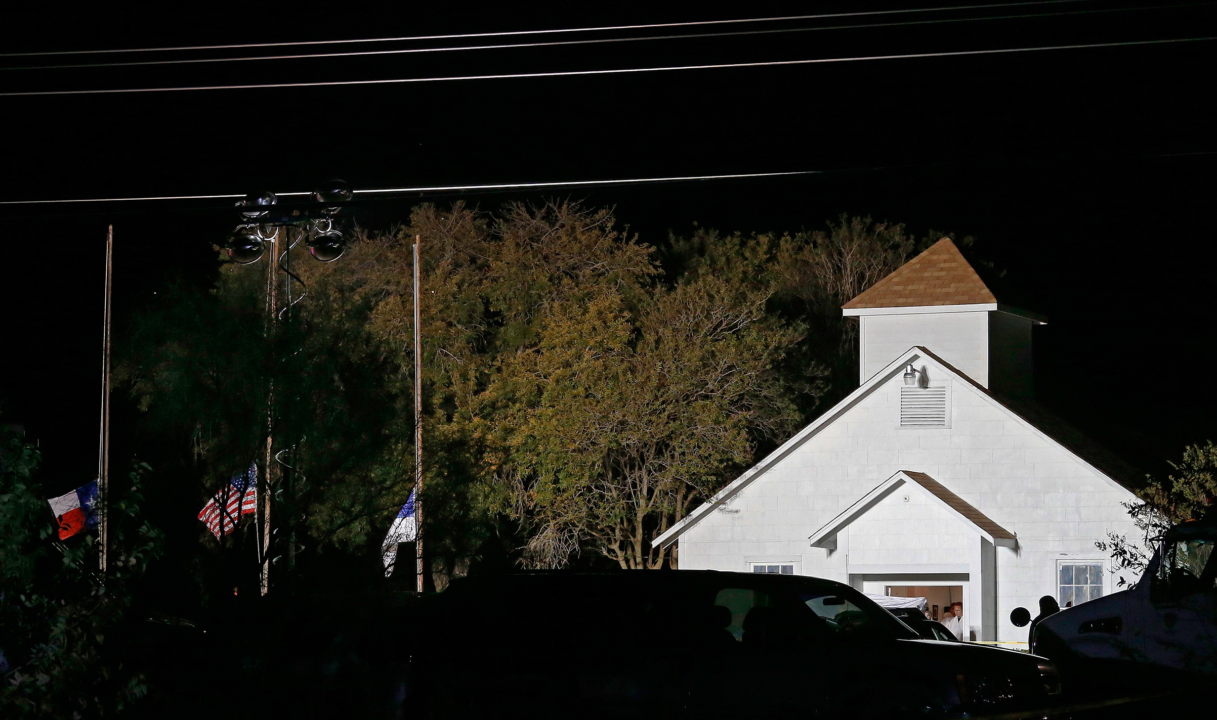 The First Baptist Church in Sutherland Springs is illuminated by raised lamps as investigators work, hours after the shooting on Nov. 5 (Larry W. Smith—EPA-EFE/REX/Shutterstock)