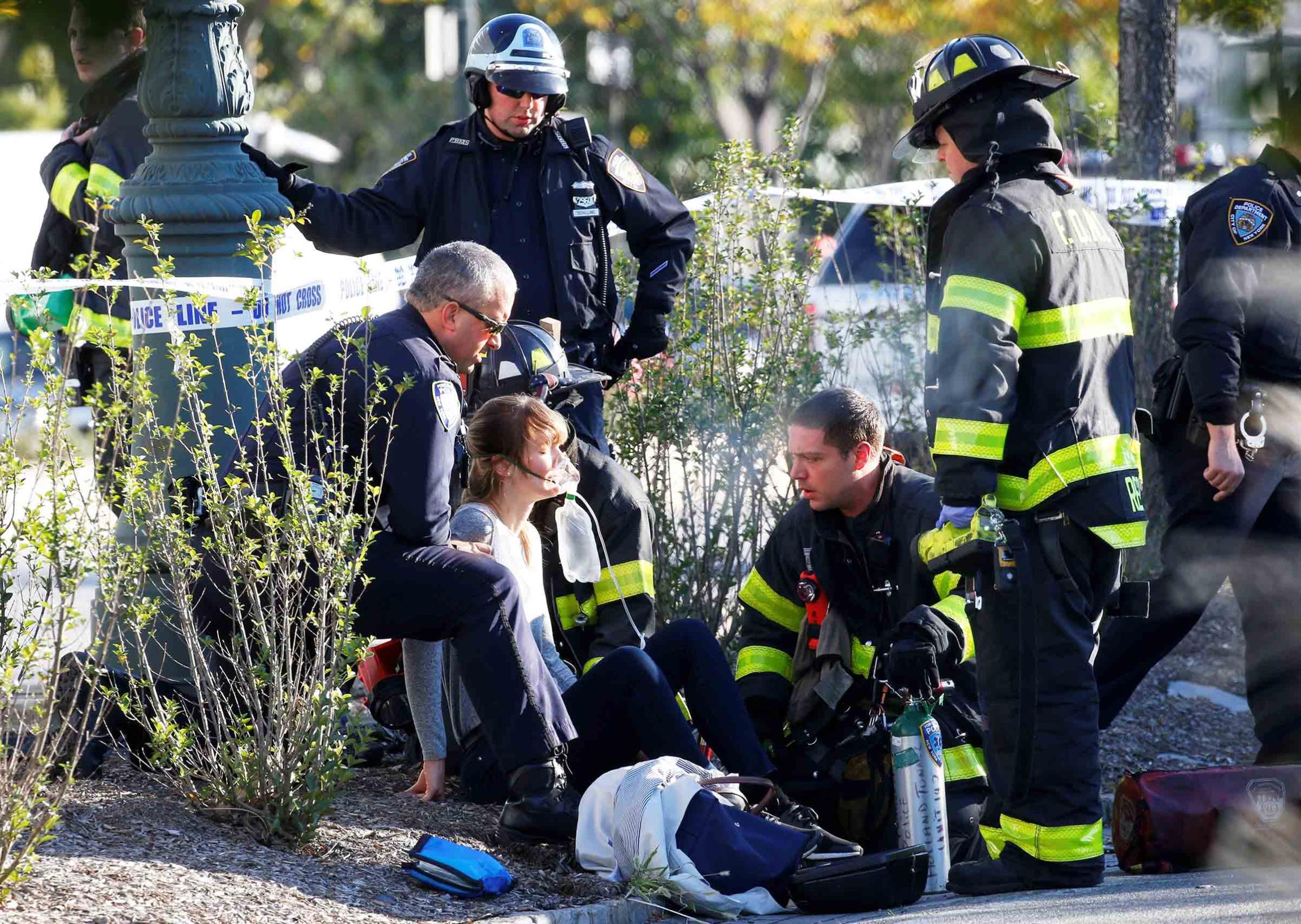 An injured woman is given oxygen by first responders after the terrorist attack