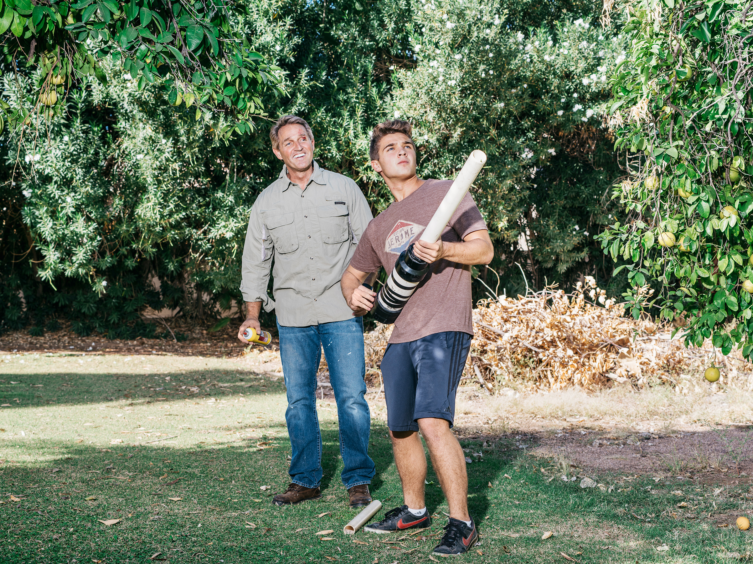 The senator and his son Dallin play with a homemade grapefruit cannon in the family's Arizona backyard. (Michael Friberg for TIME -)