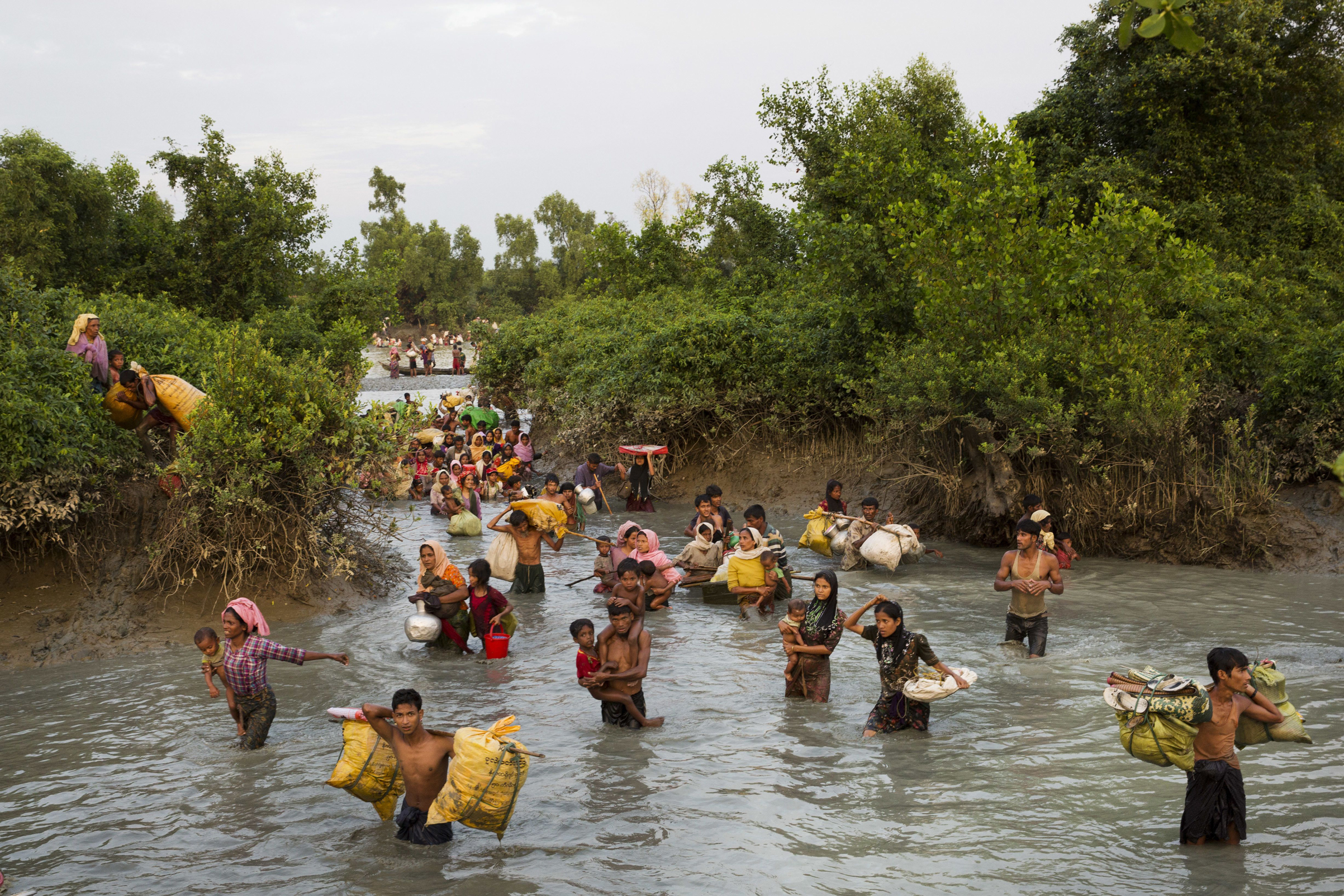 Rohingya wade through the Naf River after having just crossed over from Myanmar into Bangladesh, near Palong Khali, Bangladesh, on Nov. 1, 2017. (Bernat Armangue—AP/Shutterstock)