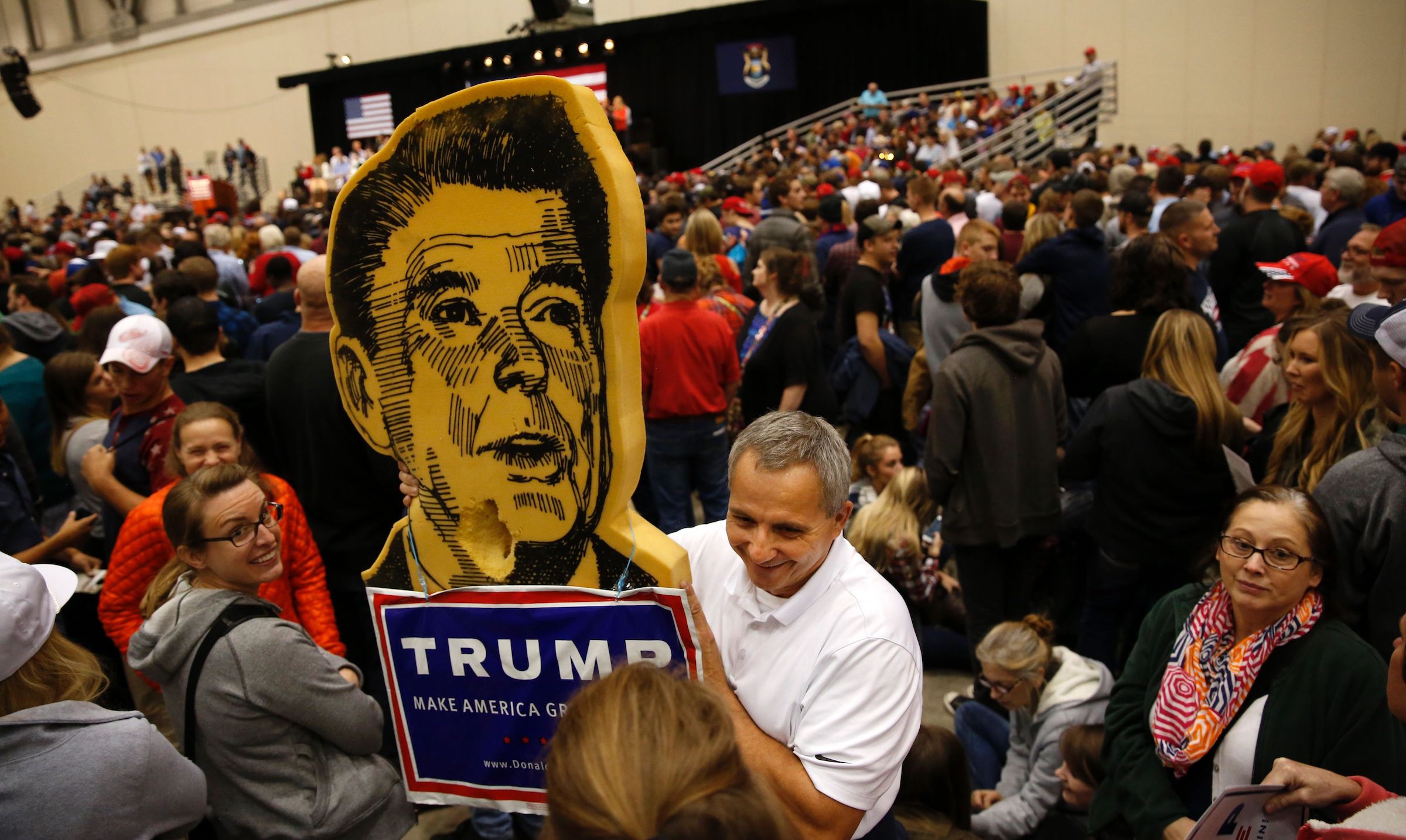 Ted Wright holds a foam campaign prop from 1980 of former U.S. President Ronald Reagan prior to the final campaign event of U.S. Republican Presidential candidate Donald Trump at Devos Place on November 7, 2016 in Grand Rapids, Michigan. (Jeff Kowalsky—AFP/Getty Images)