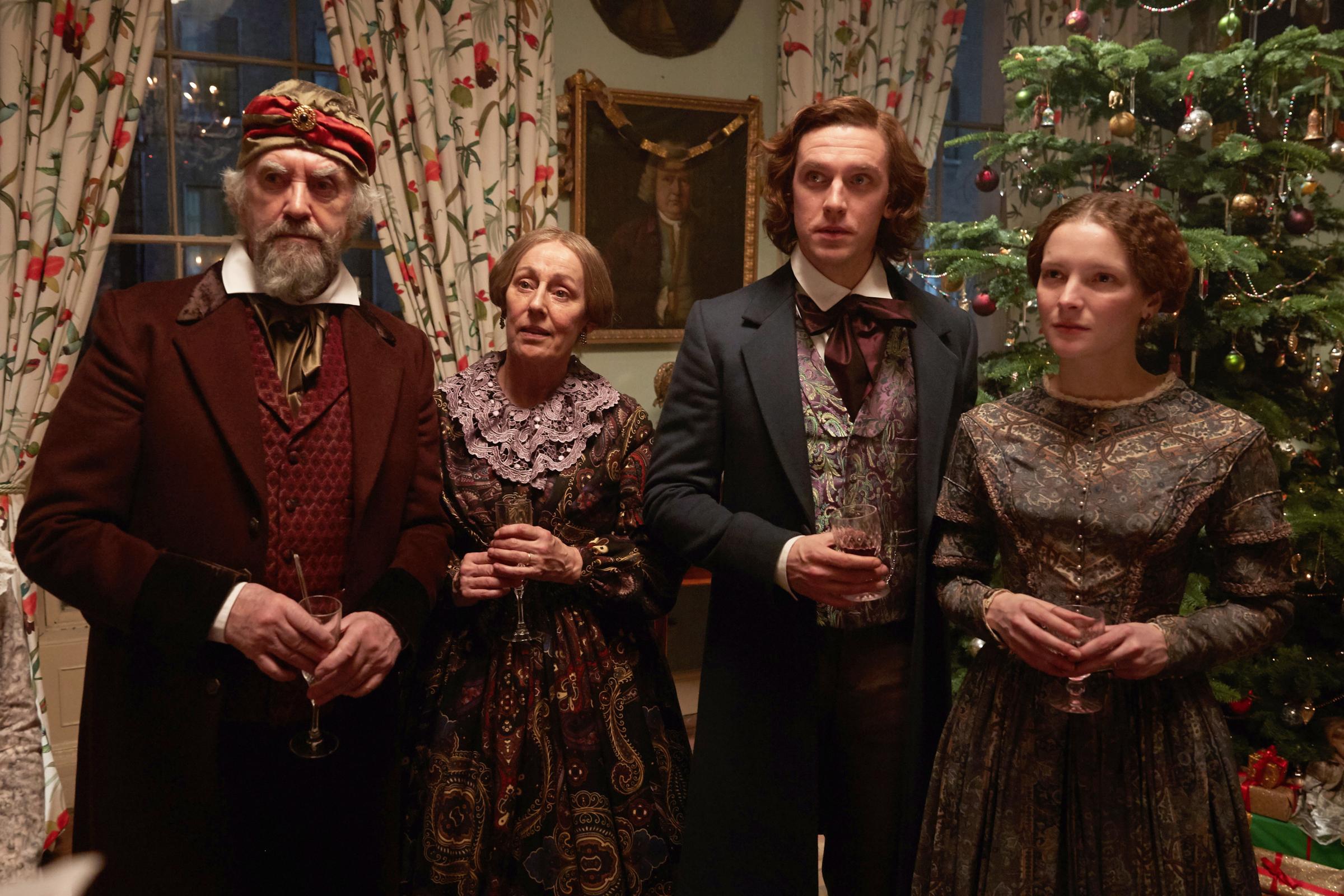 (L to R) Jonathan Pryce as Mr. John Dickens, Ger Ryan as Mrs. Dickens, Dan Stevens as Charles Dickens, and Morfydd Clark as Kate Dickens in director Bharat Nalluri’s THE MAN WHO INVENTED CHRISTMAS, a Bleecker Street release.Credit: Kerry Brown / Bleecker Street