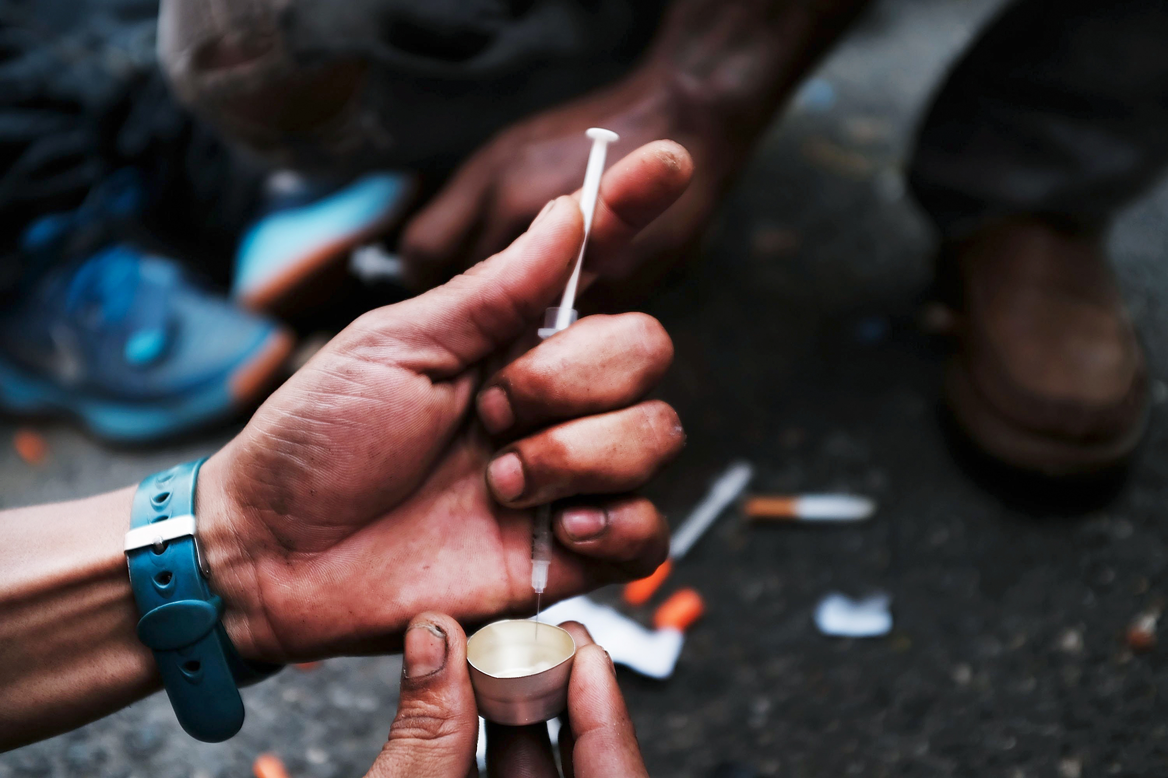 A user prepares to take heroin on a New York City street in the South Bronx on Oct. 7 (Spencer Platt—Getty Images)