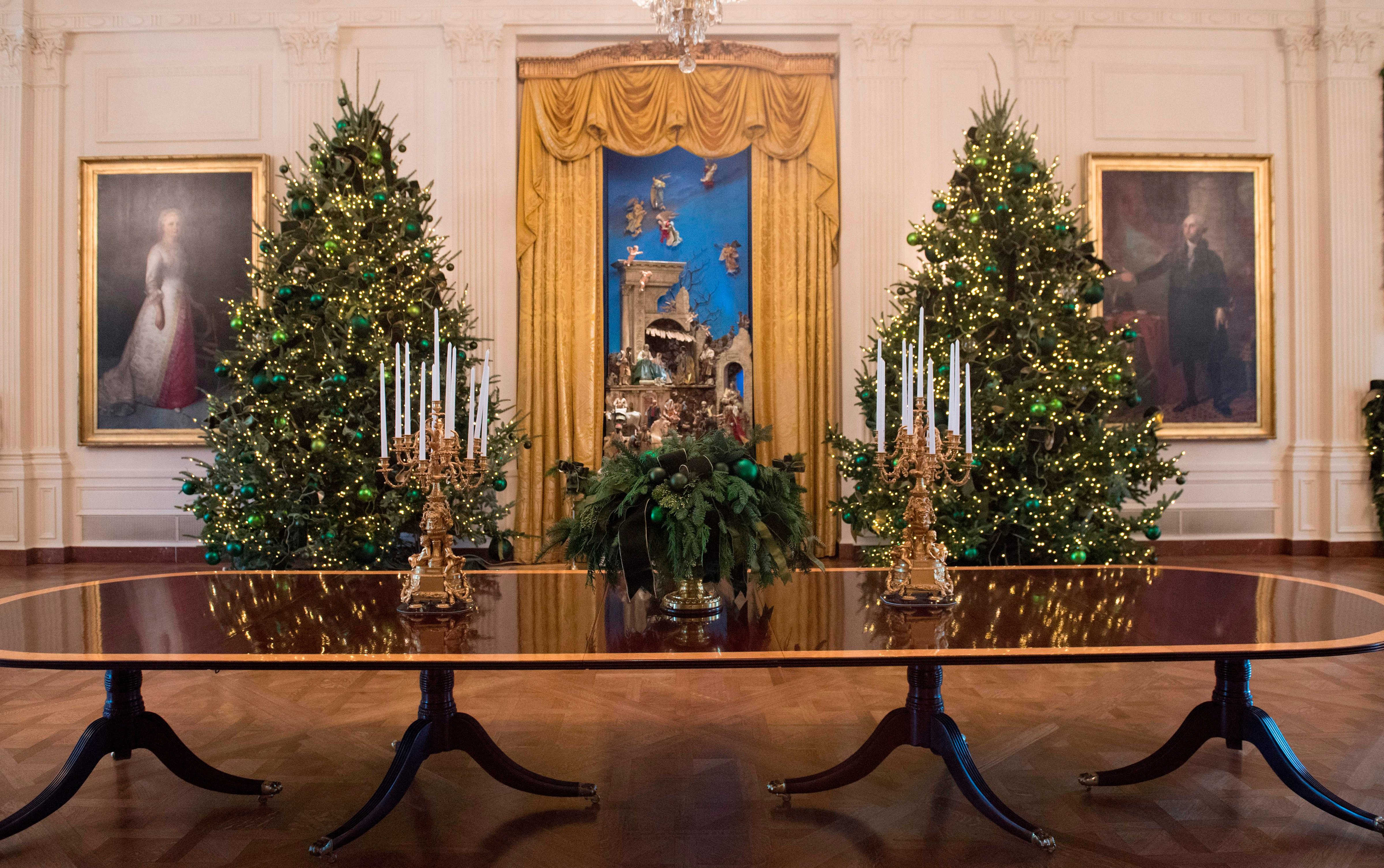 Christmas trees are seen during a preview of holiday decorations in the East Room of the White House in Washington, DC, November 27, 2017. (Saul Loeb—AFP/Getty Images)