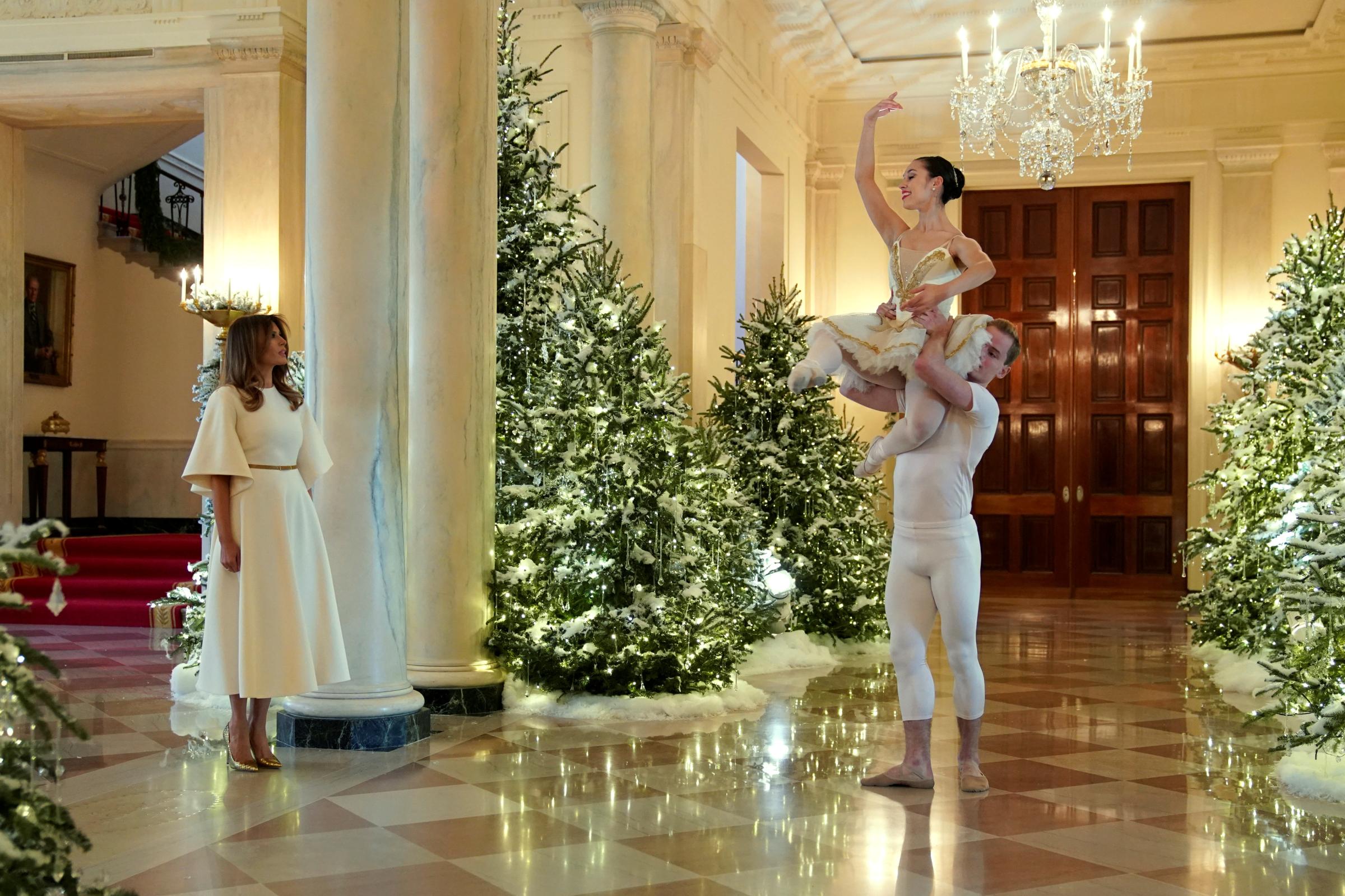 Ballet dancers perform as U.S. first lady Melania Trump begins a tour of the holiday decorations