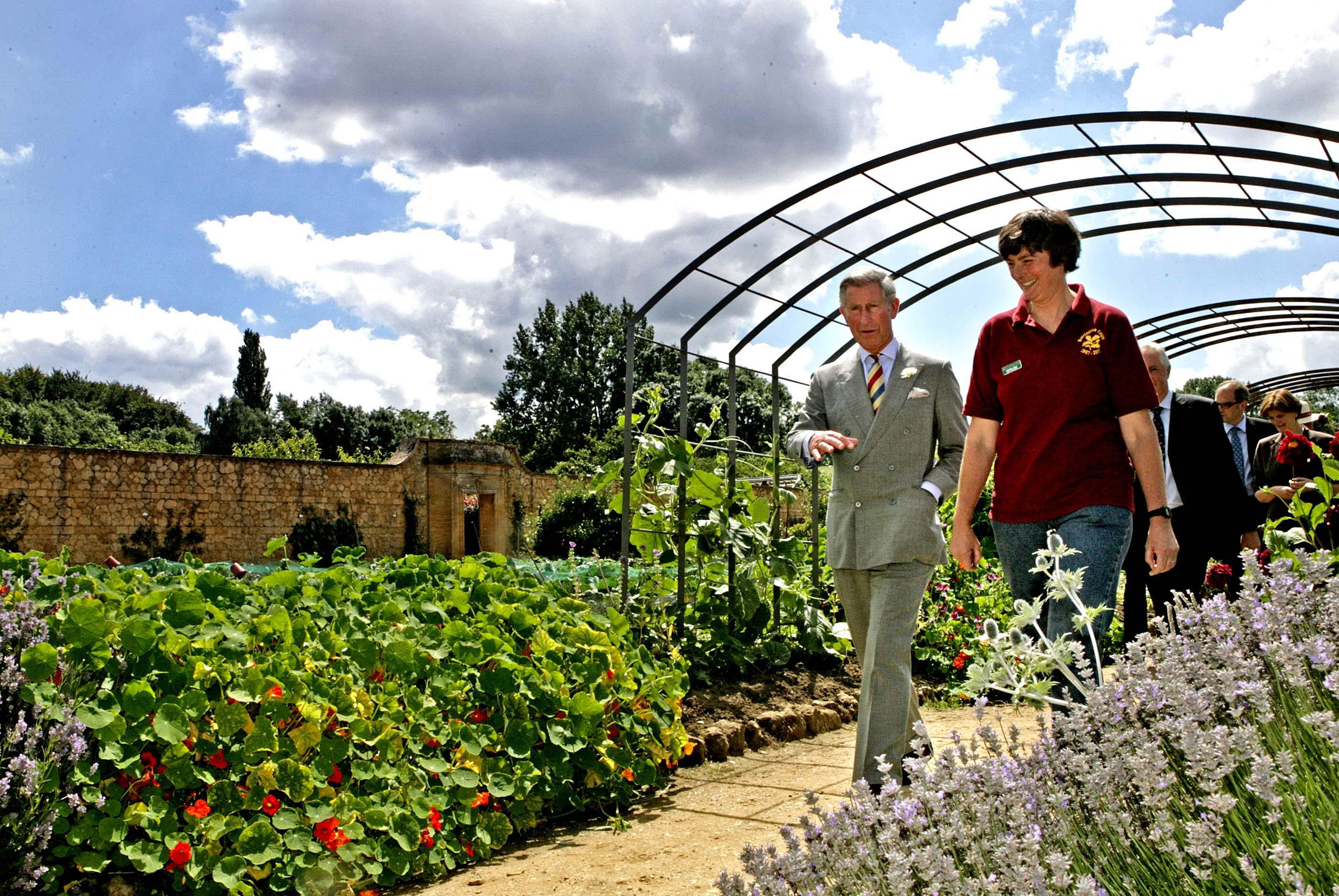 Prince Charles, Prince of Wales and head gardener Christine Brain tour the Gertrude Jekyll inspired Arts and Crafts Garden at Barrington Court on July 18, 2007 in Barrington, England. (Photo by Pool/Anwar Hussein Collection/WireImage) (Anwar Hussein Collection/ROTA&mdash;WireImage)