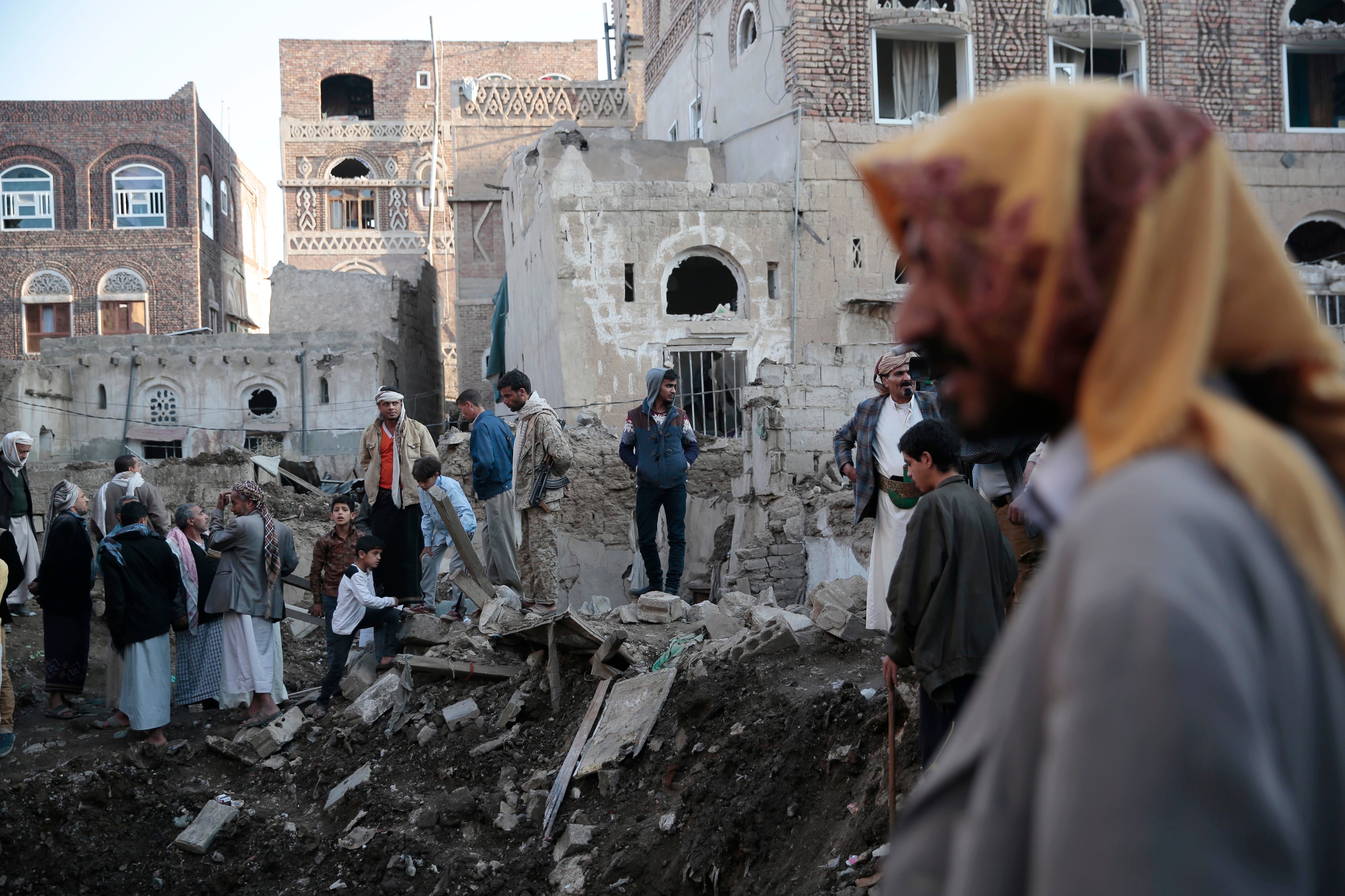 People search through the rubble of houses at the site of a Saudi-led airstrike near Yemen's Defense Ministry complex in Sanaa, Yemen, on Nov. 11, 2017. (Hani Mohammed—AP)