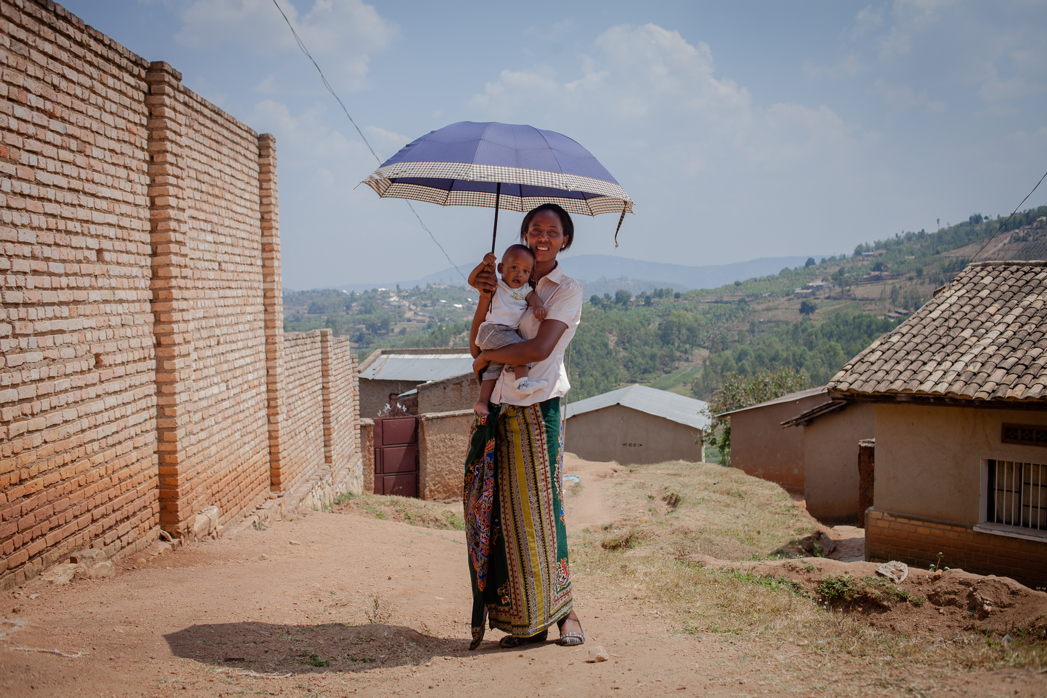 A portrait of Franciose Mukeshimana with her eight month old baby Bertrand in front of their home in Muhanga on July 21, 2017. She was the first mother to receive blood from Zipline at Kabgayi Hospital in Muhanga district. (Esther Mbabazi for TIME)