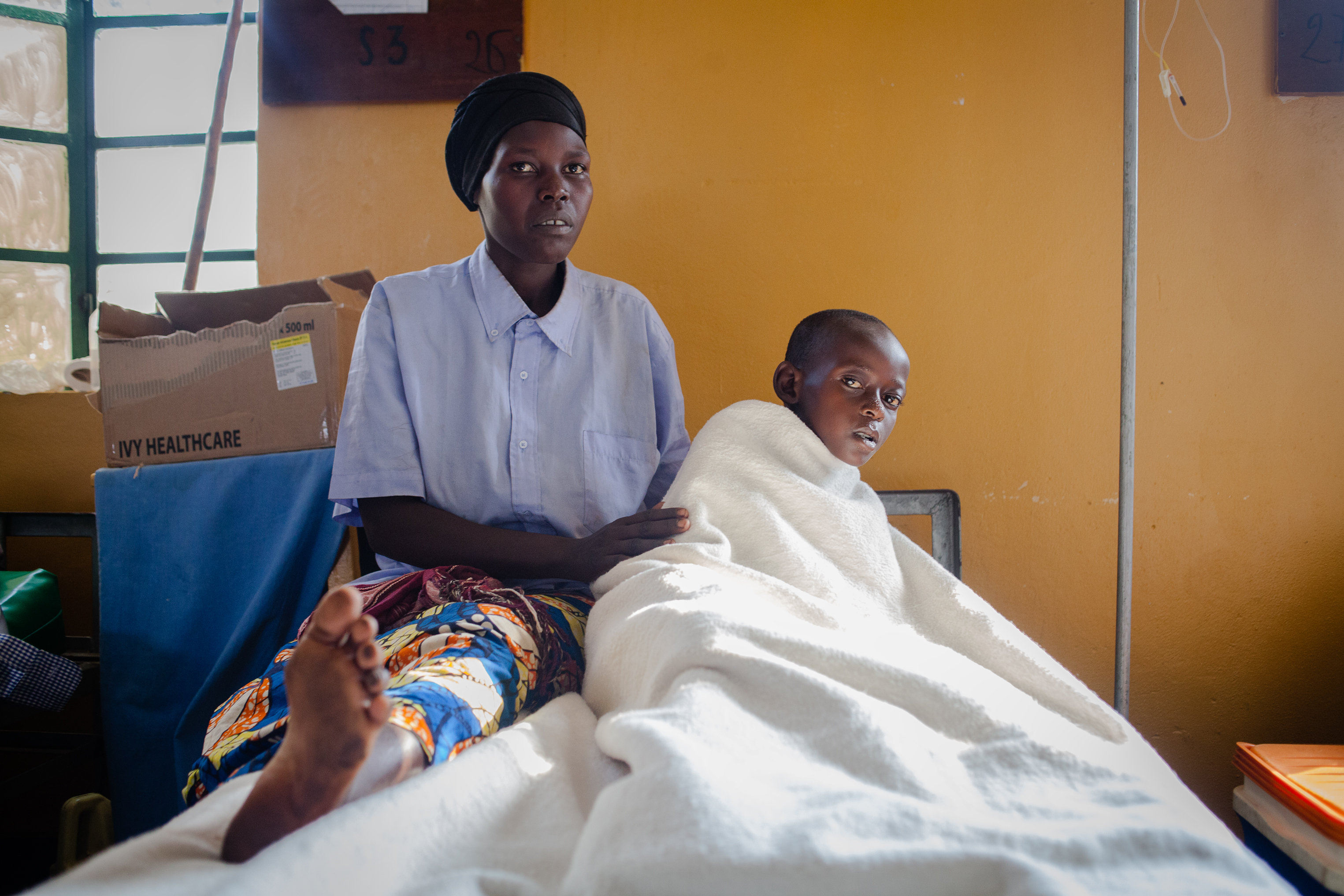 Donata Mubandakazi with her 10 year-old son Jean following surgery for an unidentified infection on his leg. He was given plasma from a Zipline drone. (Esther Mbabazi for TIME)