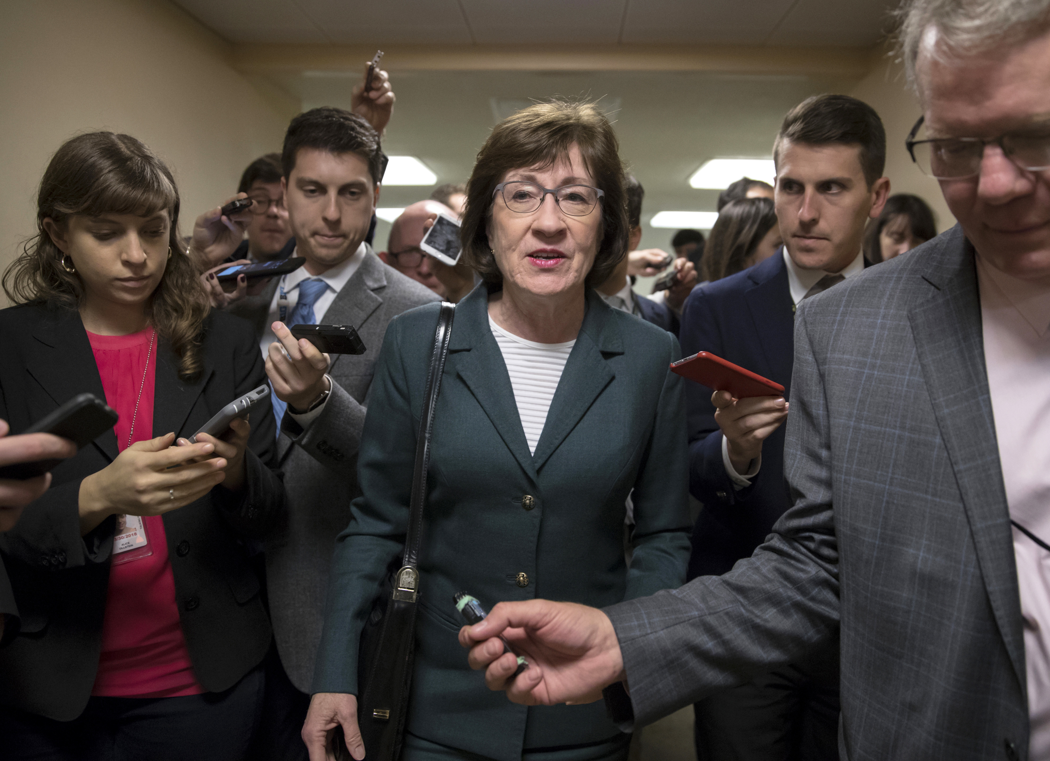 In this Nov. 30, 2017, file photo, with reporters looking for updates, Sen. Susan Collins, R-Maine, and other senators rush to the chamber to vote on amendments as the Republican leadership works to craft their sweeping tax bill in Washington. (J. Scott Applewhite&mdash;AP)
