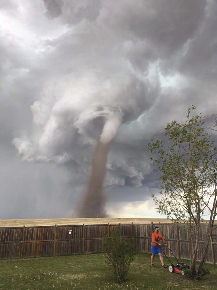 Cecilia Wessels took the image of her husband Theunis Wessels mowing his lawn as a tornado swirled menacingly in the background. She did it to show her parents in South Africa, and said that the twister wasn't as close it appears.  That didn't stop the full-on social media firestorm after she shared it on Facebook.