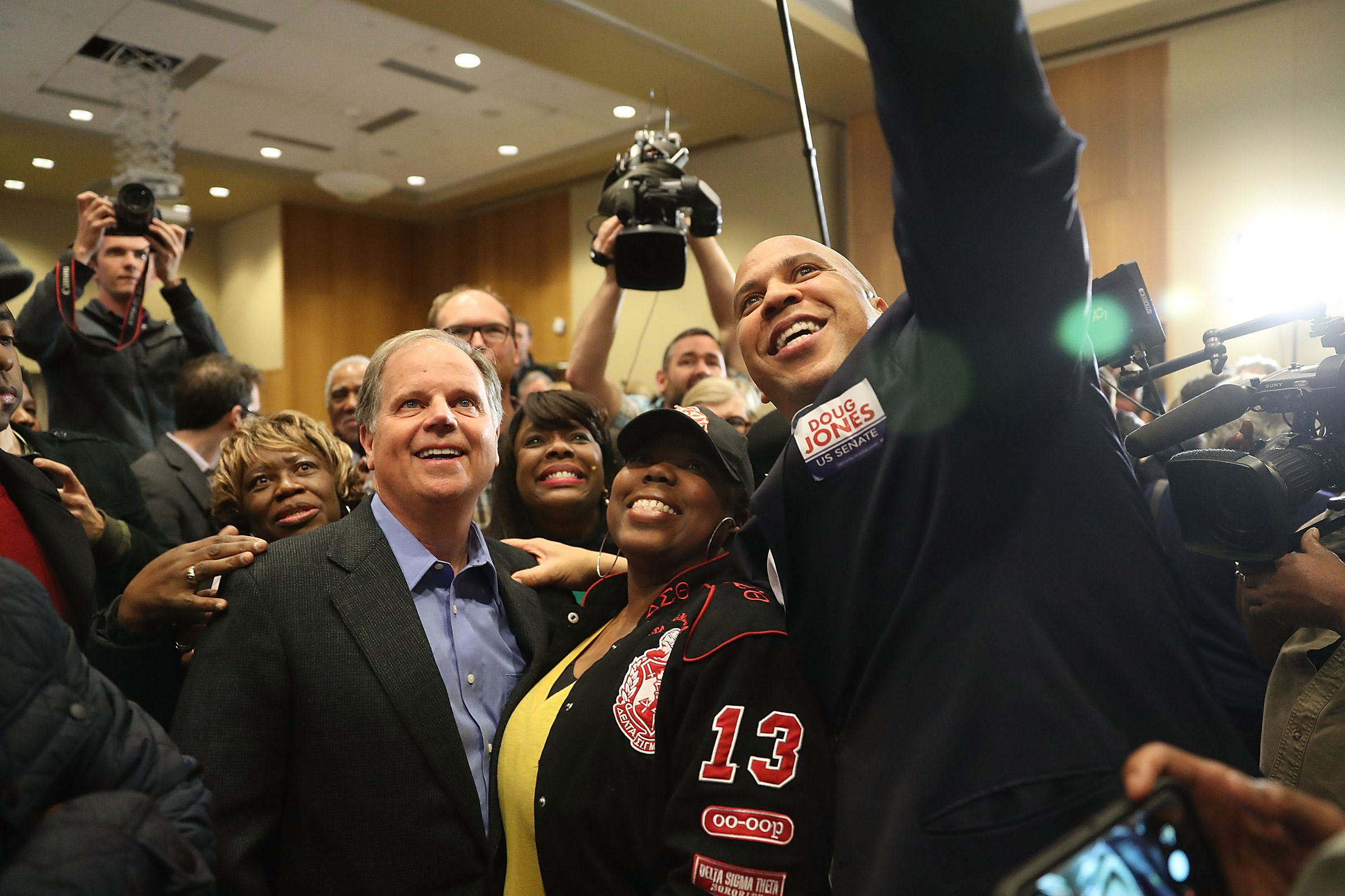 Democratic Senatorial candidate Doug Jones takes a group picture with Sen. Cory Booker (D-NJ) (R) and Rep. Terri Sewell (D-AL) (third from right) and supporters during a campaign event held at Alabama State University on December 9, 2017, in Montgomery, Alabama. (Joe Raedle—Getty Images)