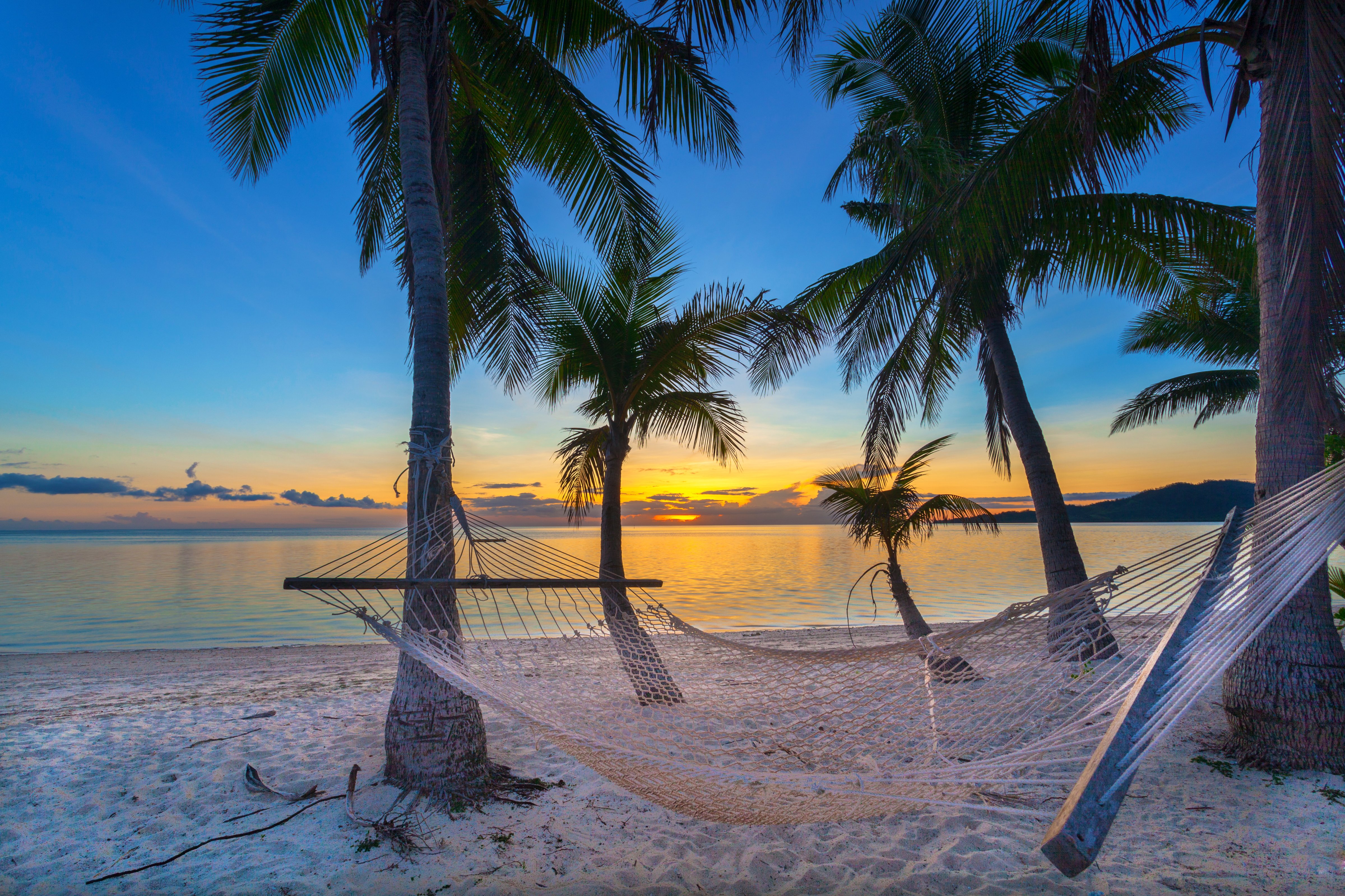 A beach at sunset in Fiji (Getty Images)