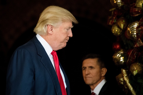 US President-elect Donald Trump (L) stands with Trump National Security Adviser Lt. General Michael  Flynn (R) at Mar-a-Lago in Palm Beach, Florida, where he is holding meetings on December 21, 2016.